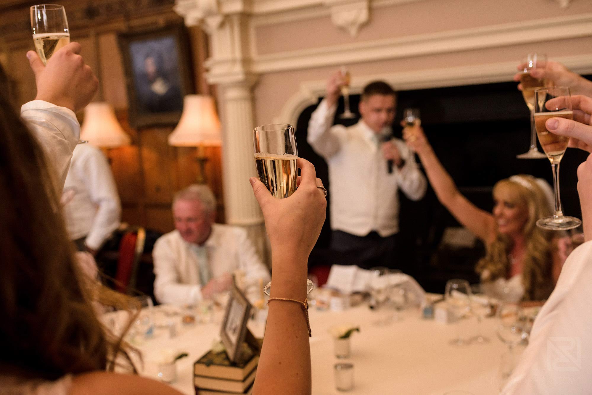 Summer wedding at Arley Hall 34 wedding party raising toast