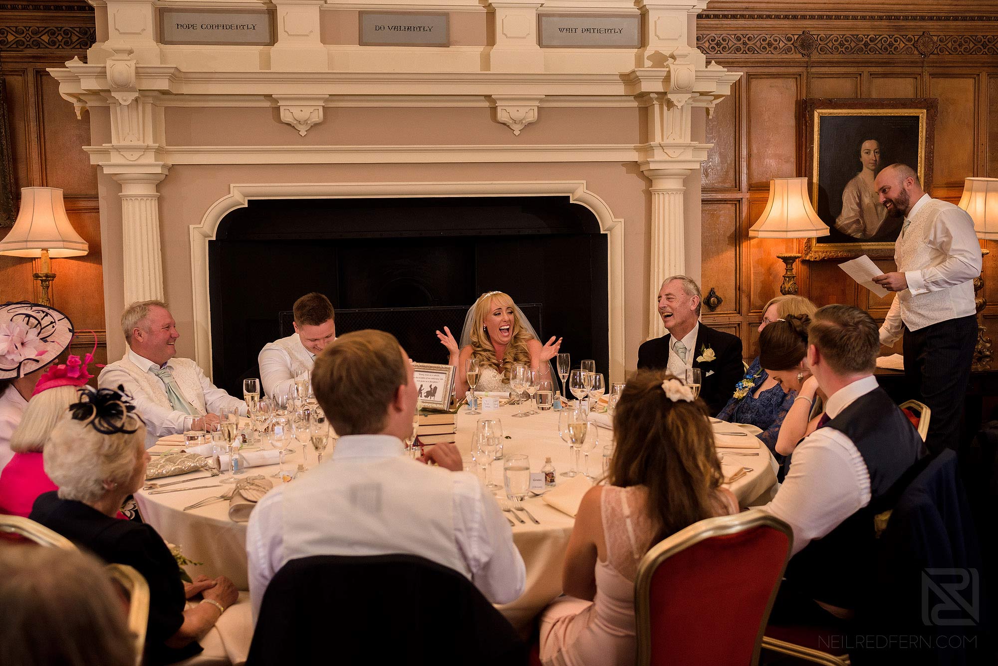 Summer wedding at Arley Hall 35 top table laughing during best man's speech