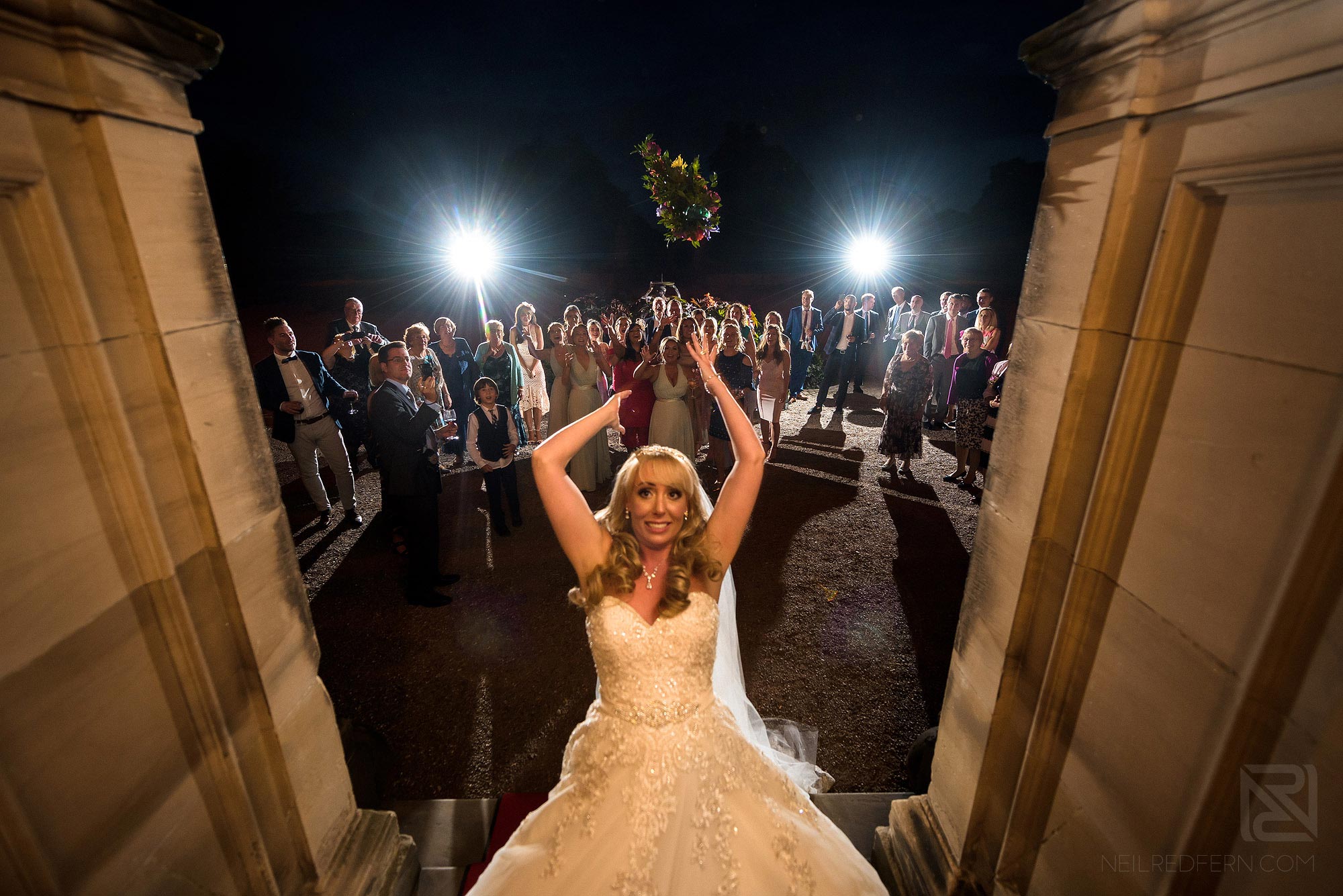 Summer wedding at Arley Hall 40 bride tossing bouquet