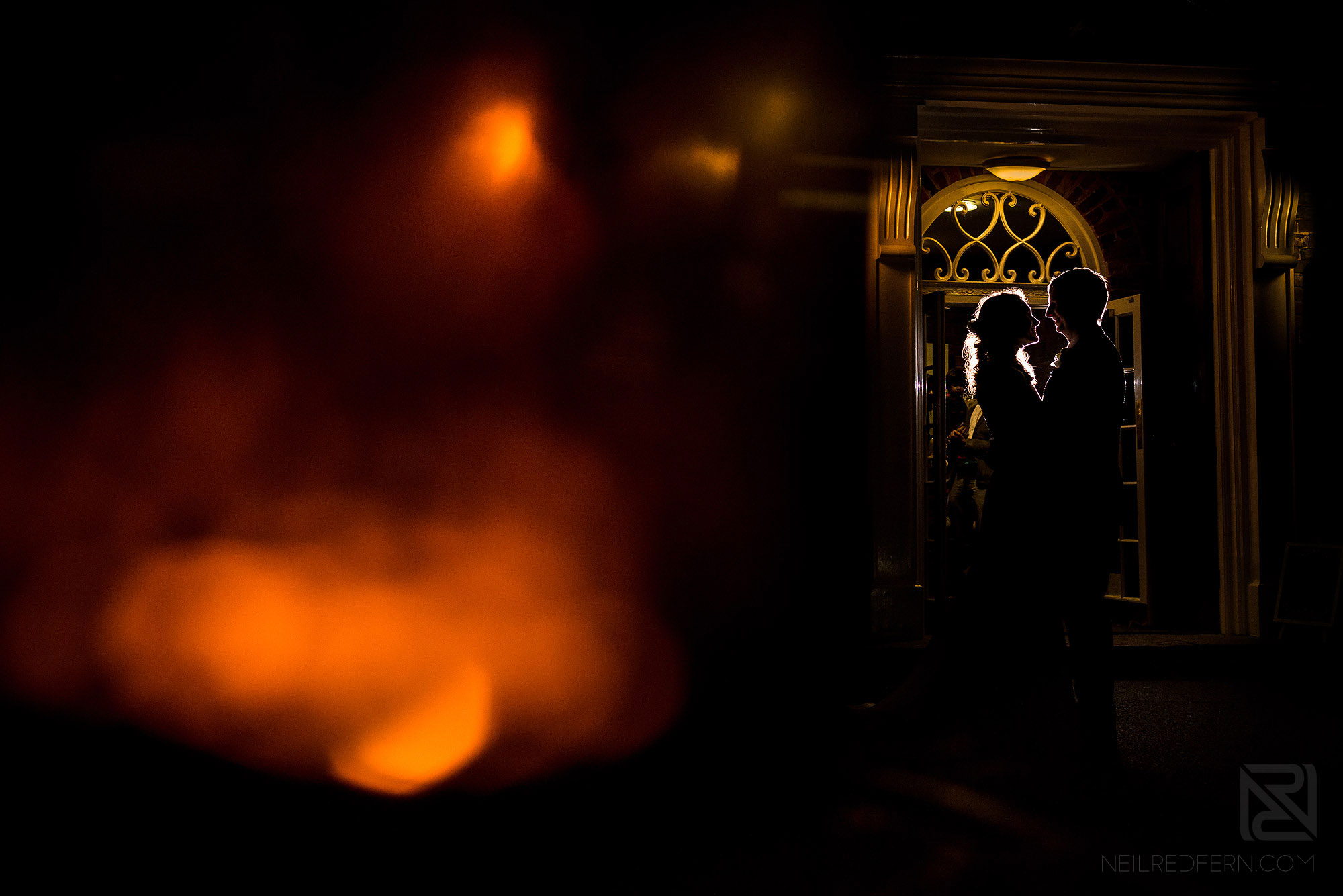 creative portrait of bride and groom at night outside Adlington Hall
