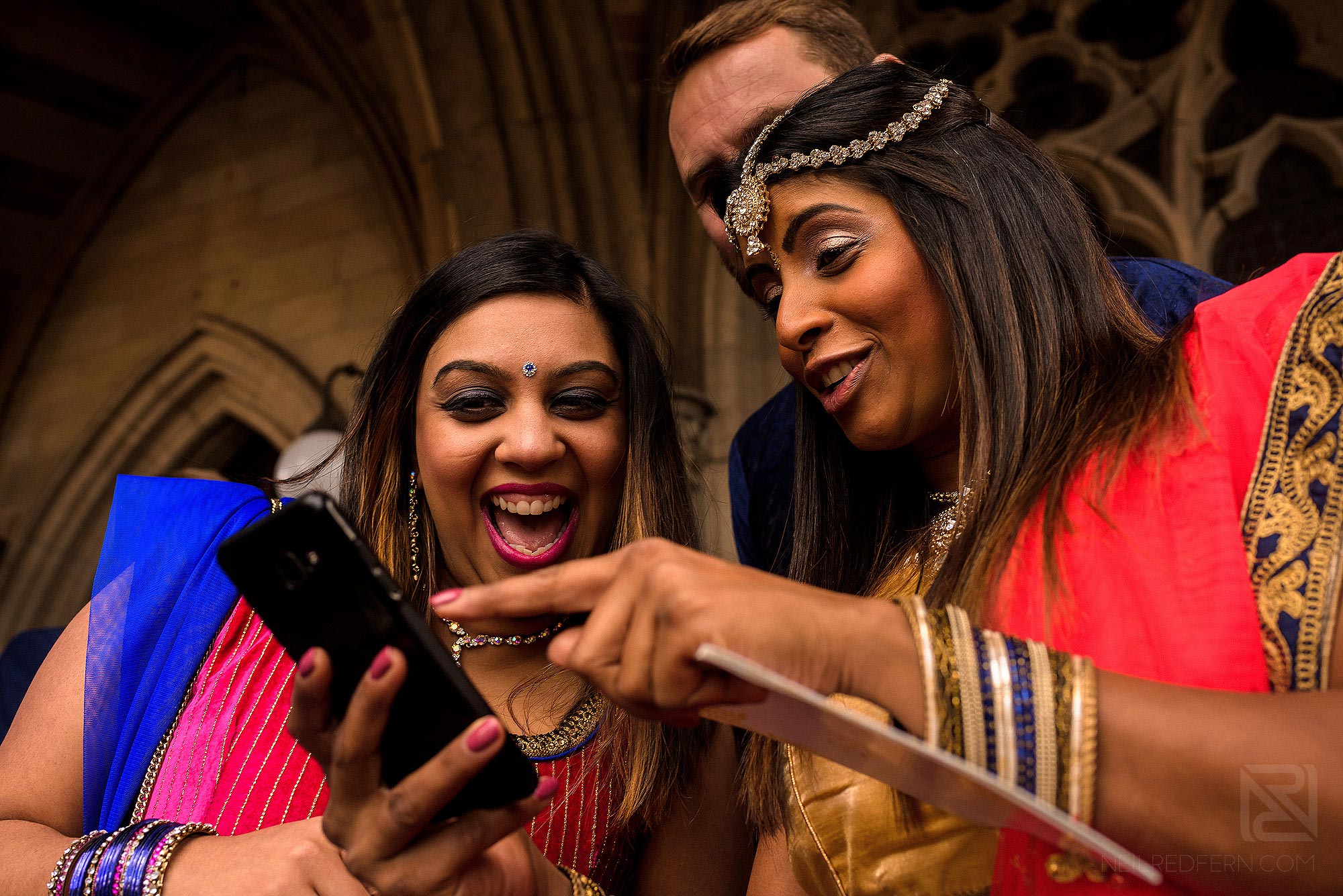 wedding guests laughing outside Rochdale Town Hall