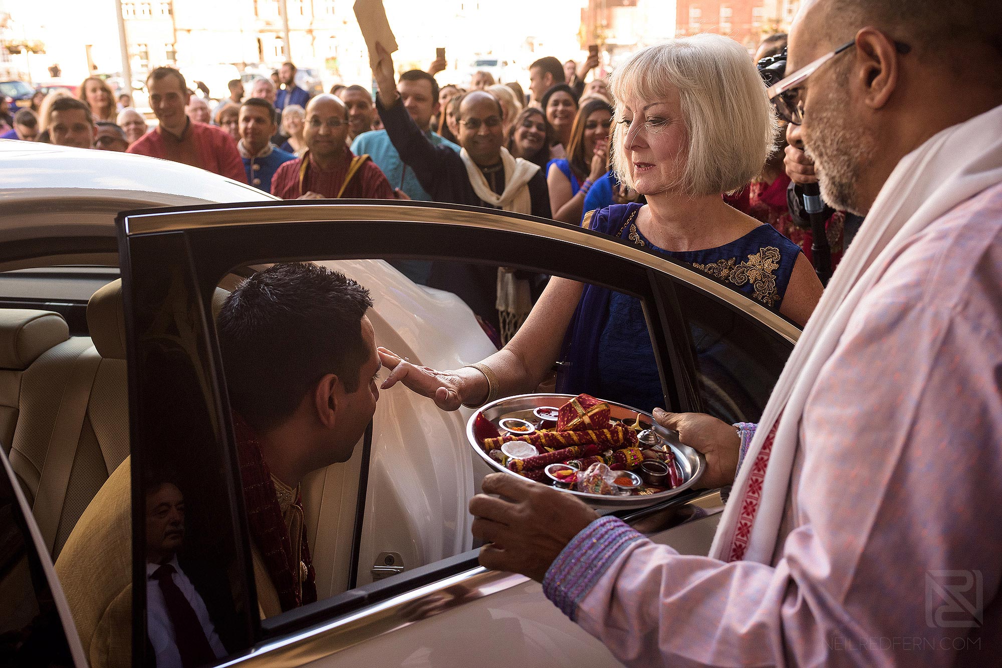 Indian groom getting out of car for wedding at Rochdale Town Hall