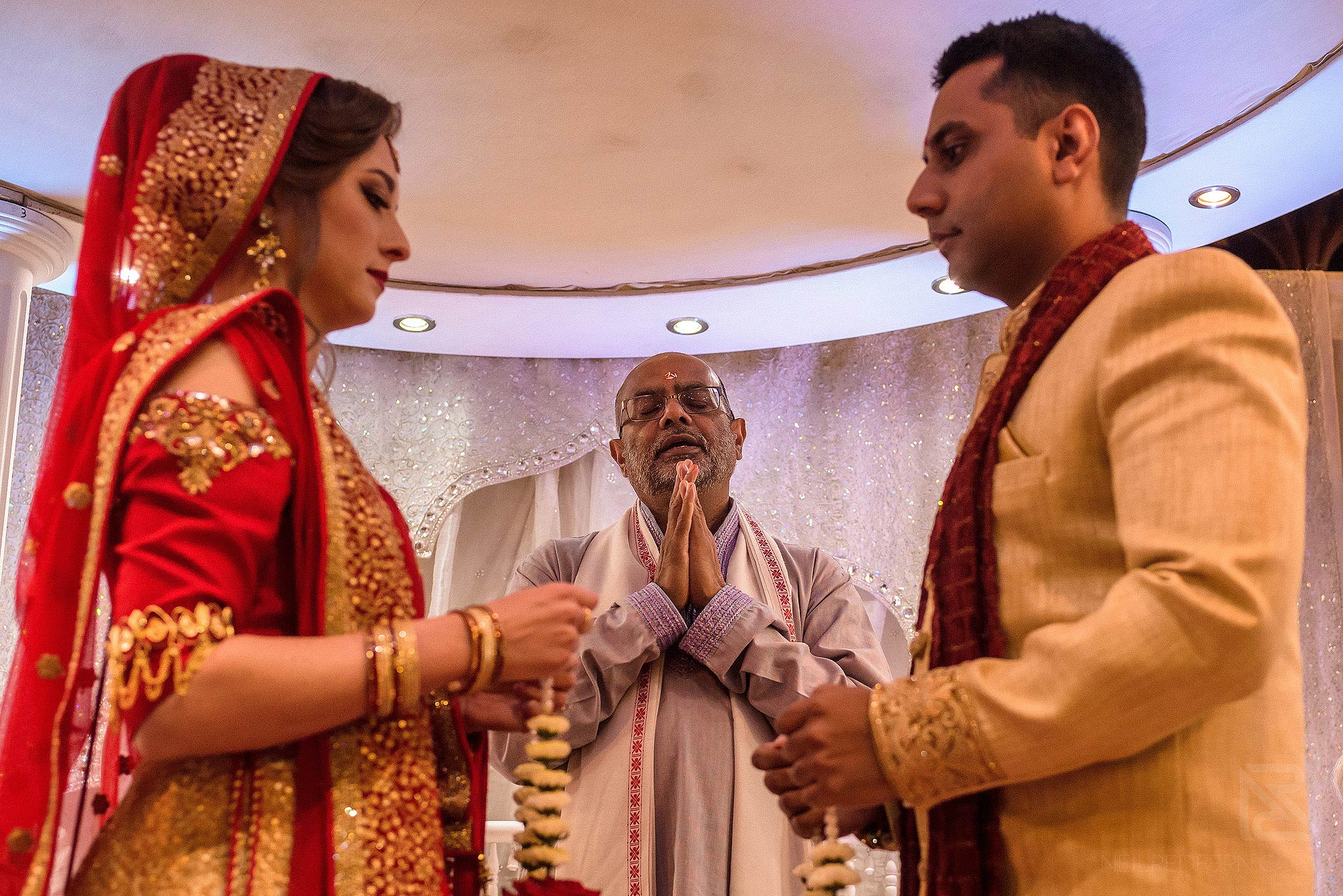 Indian bride and groom exchanging garlands