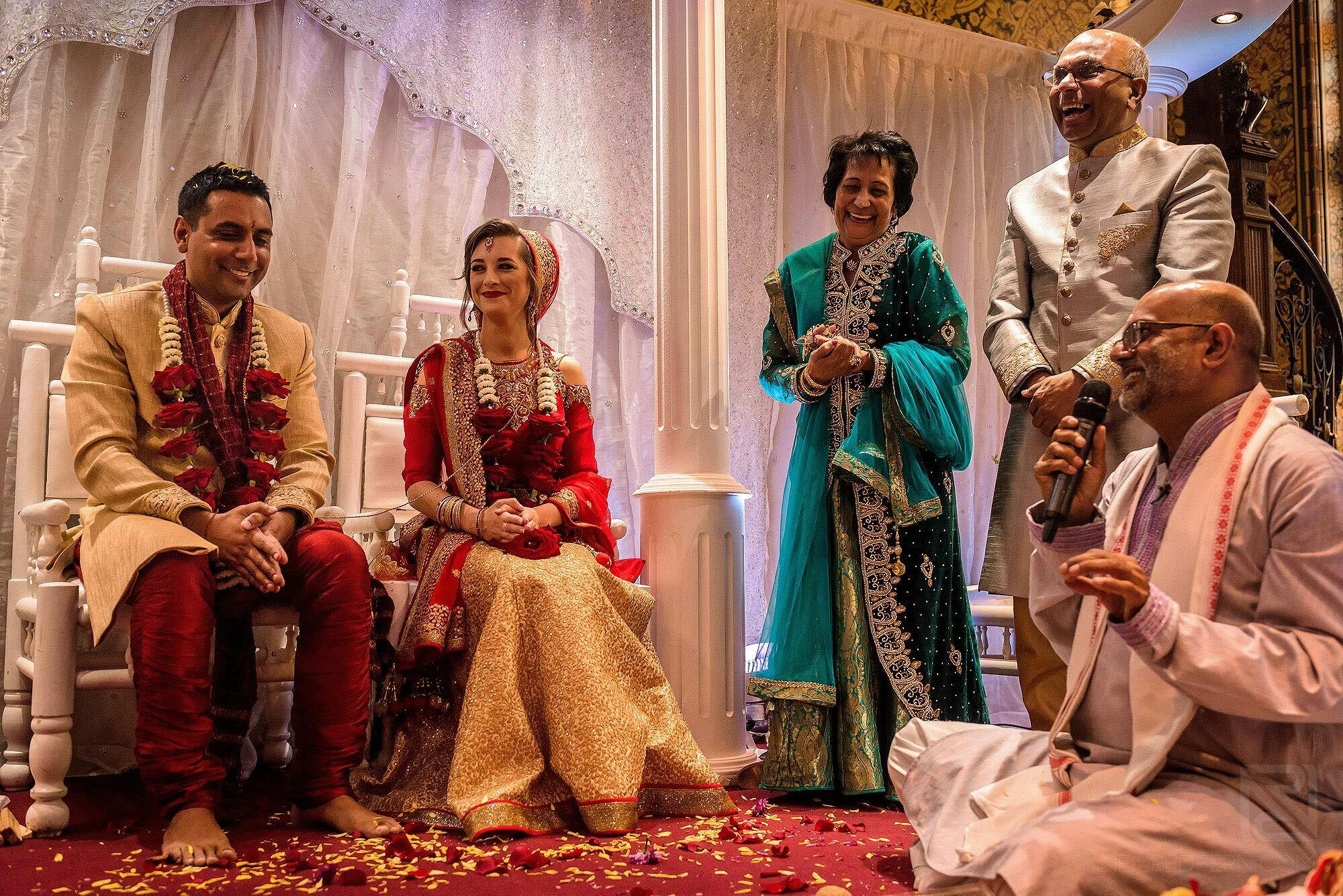 groom's family laughing under Mandap during ceremony