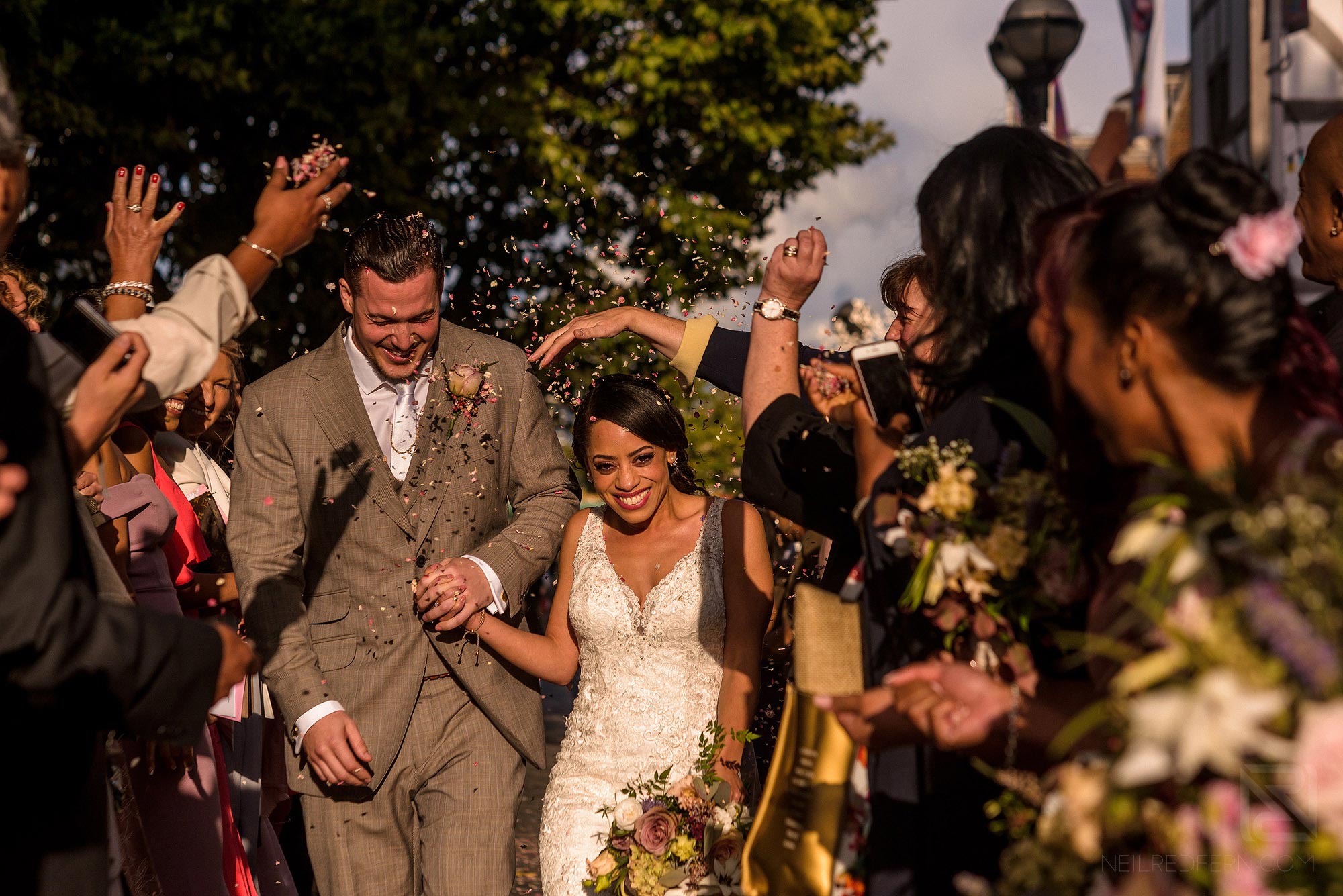 guests throwing confetti outside Shakespere's Globe in London