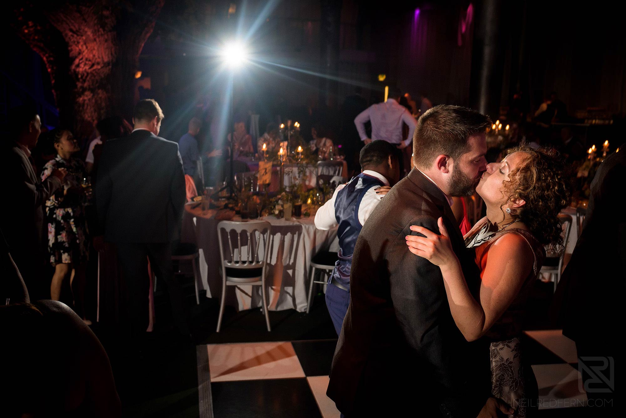 wedding guests kissing on dance floor