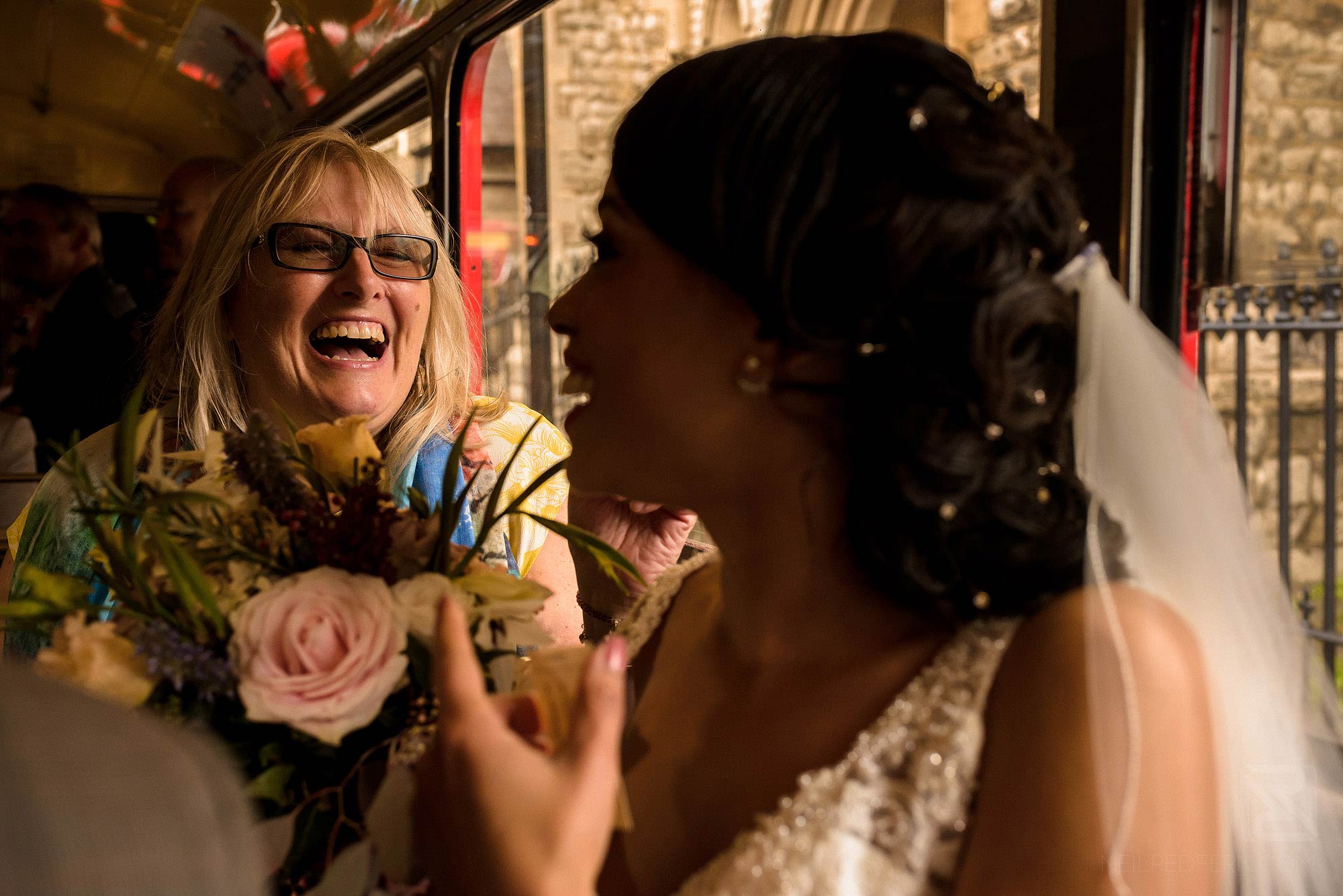 guest laughing on wedding bus