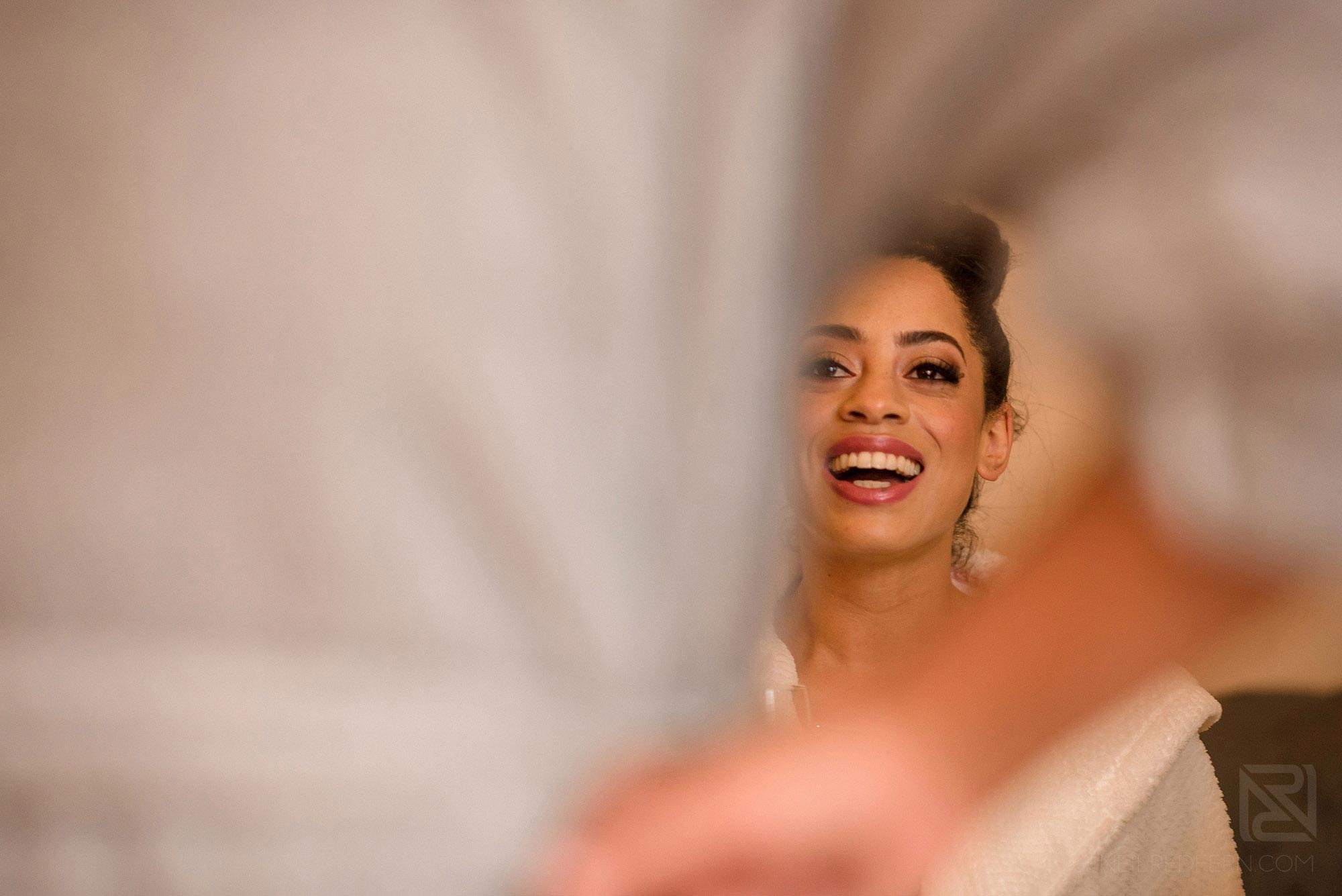 bride laughing whilst getting ready