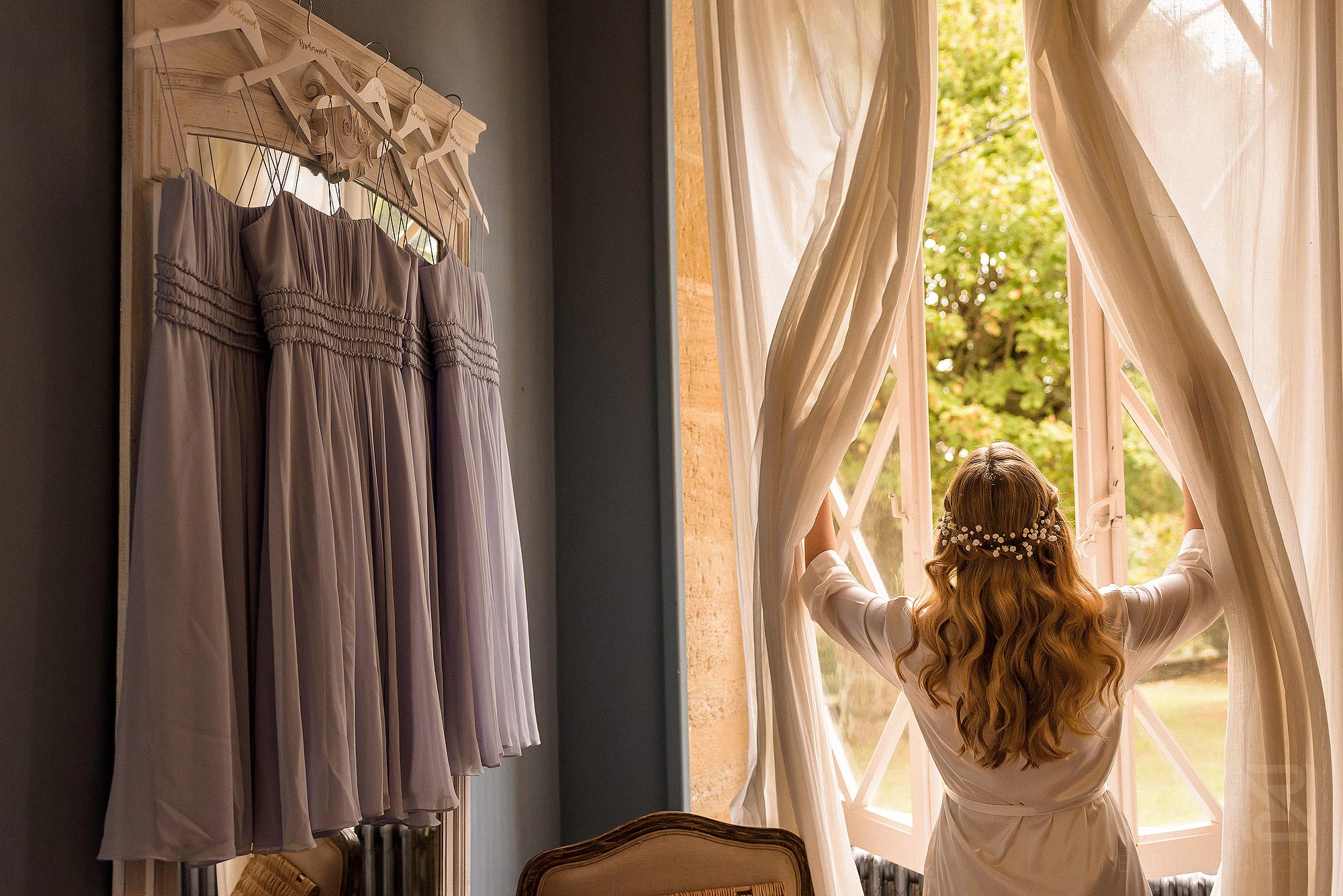 bride opening curtains 