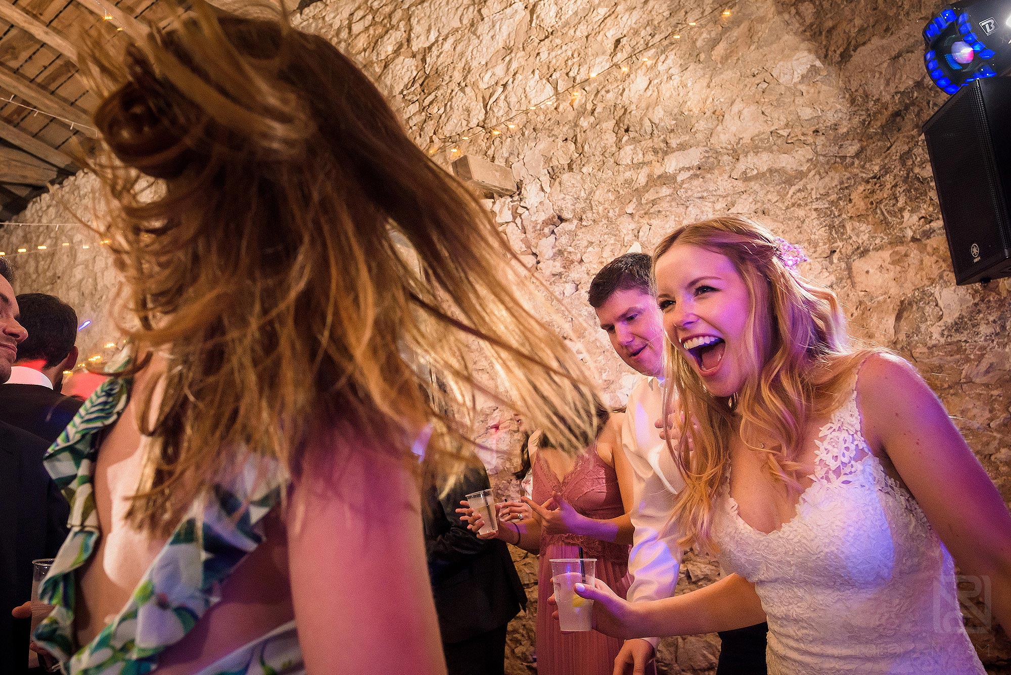 bride and friend laughing on dancefloor