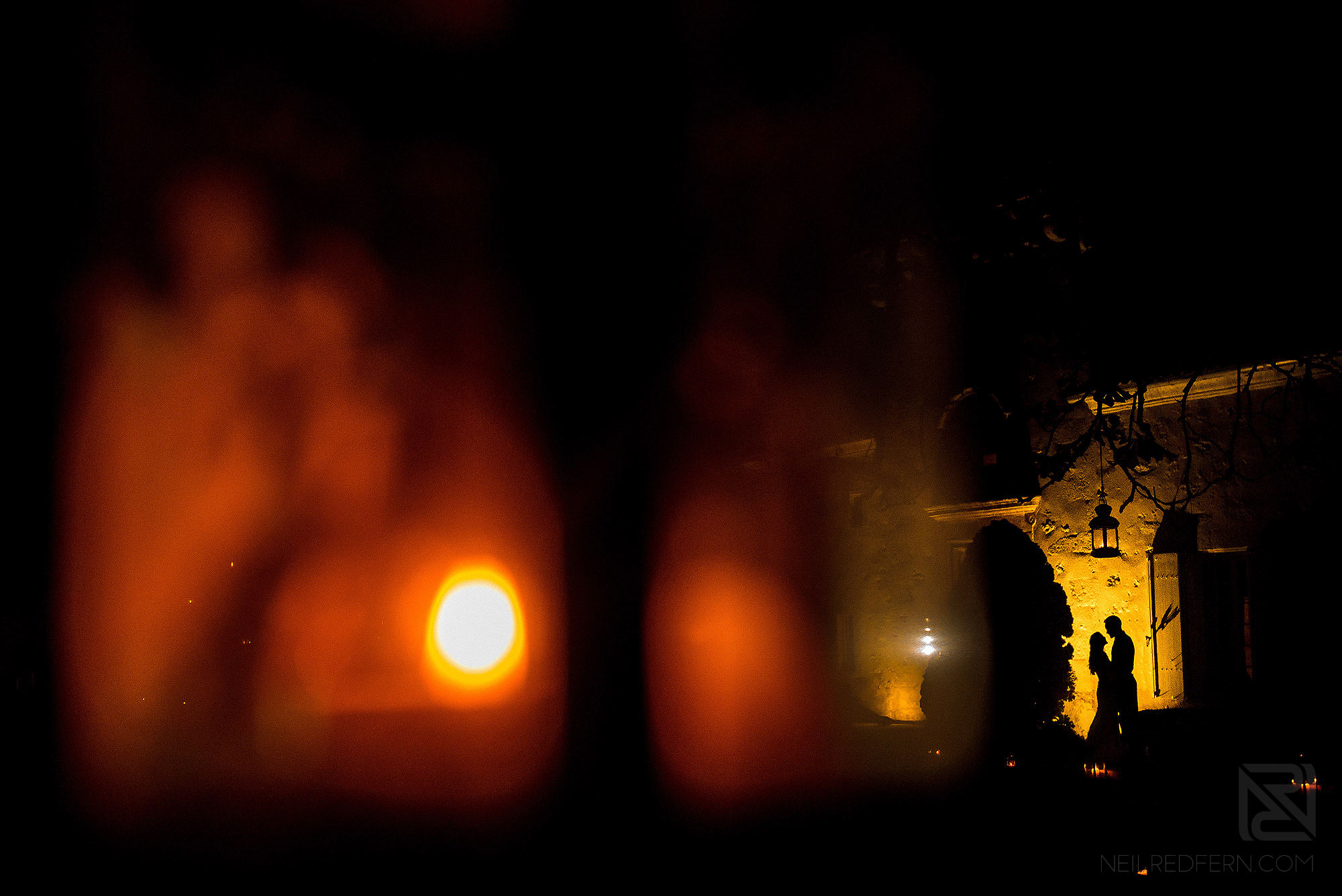 silhouette photograph of bride and groom at night