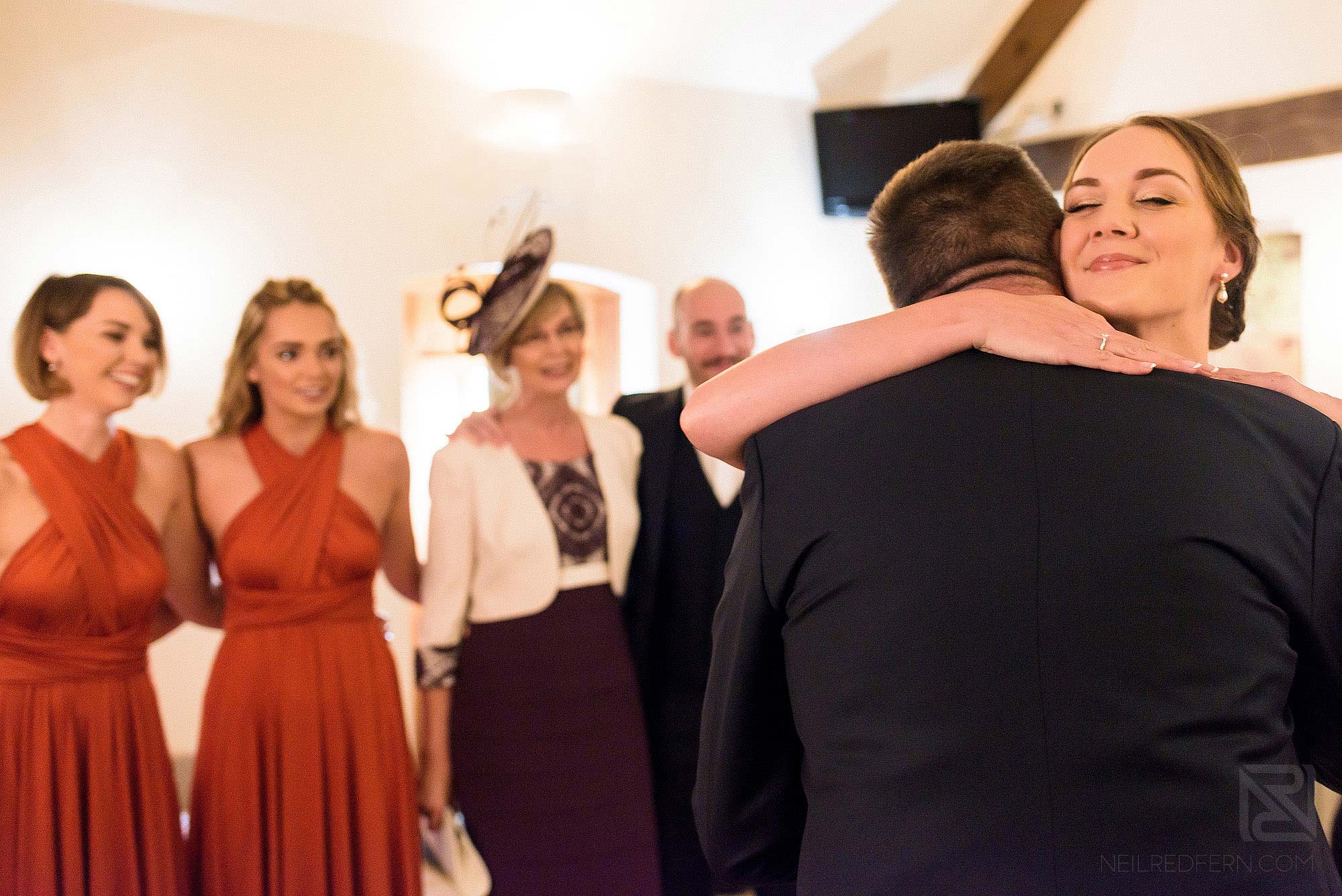 emotional bride hugging dad before wedding ceremony