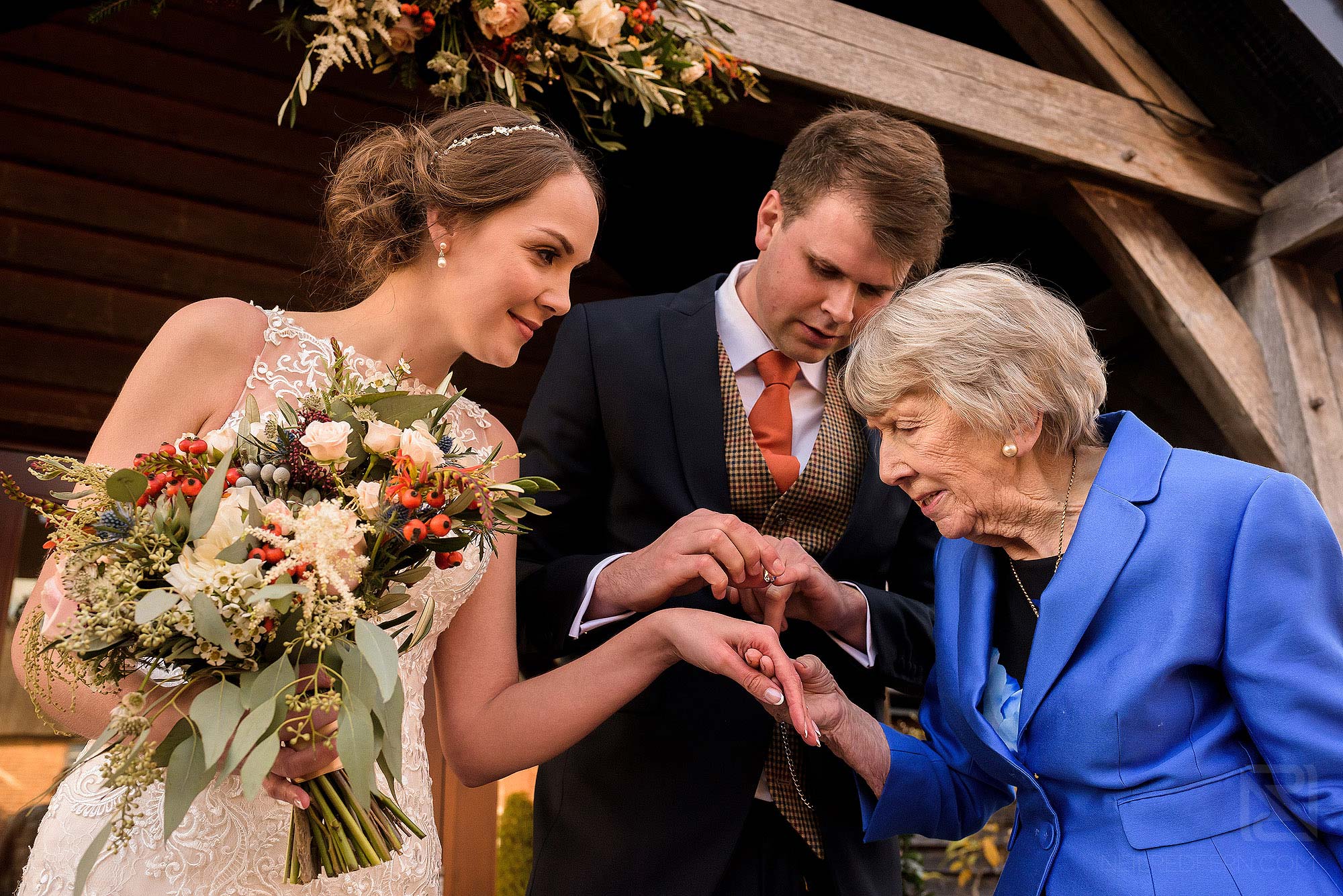 grandma looking at bride's wedding ring
