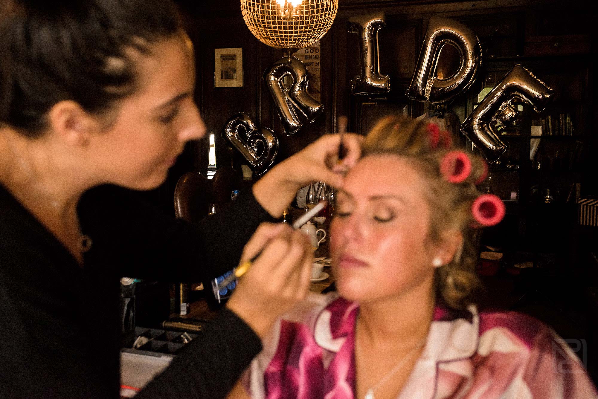 bride having make-up done on morning of wedding at Mitton Hall