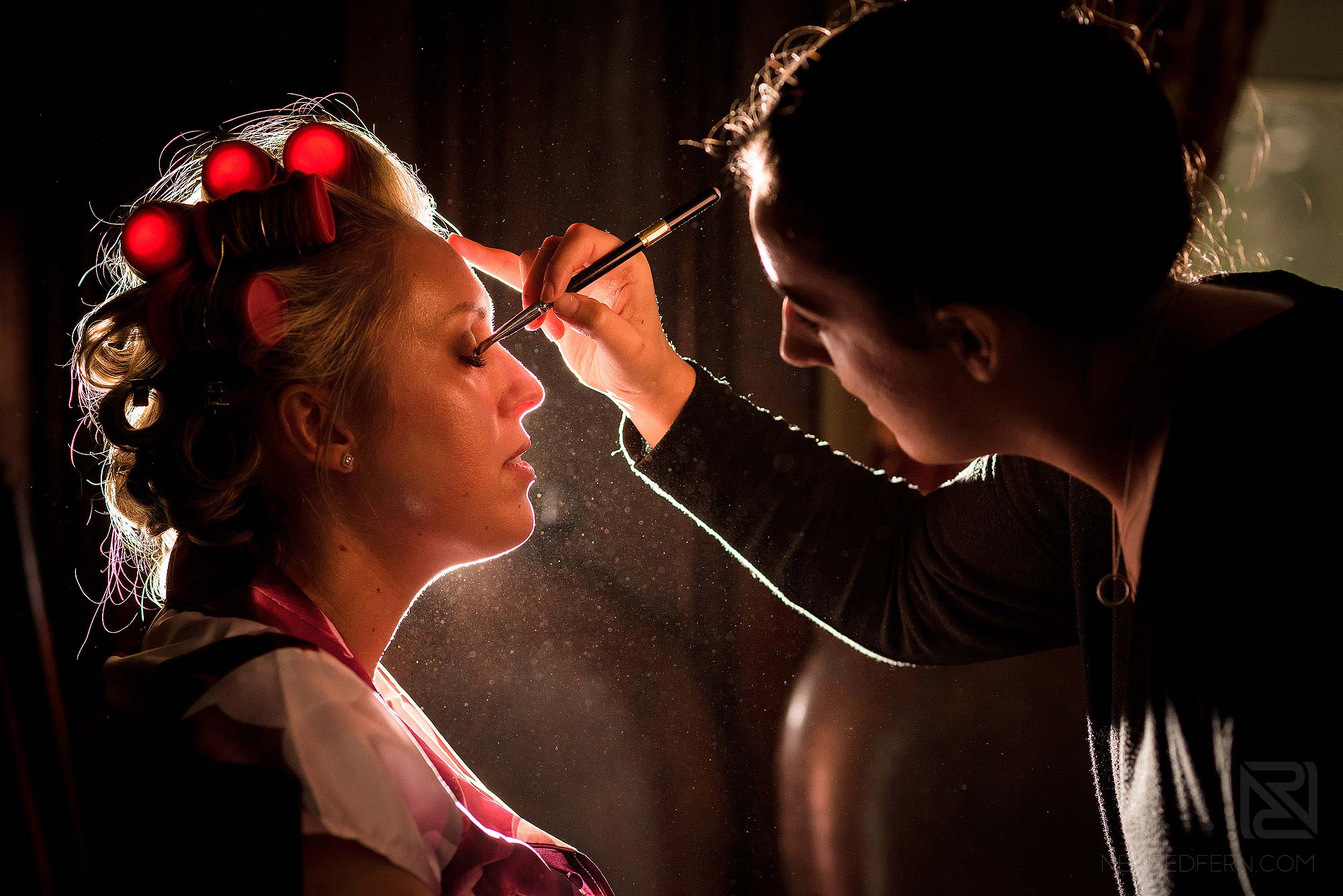 off camera flash photograph of bride having make-up put on