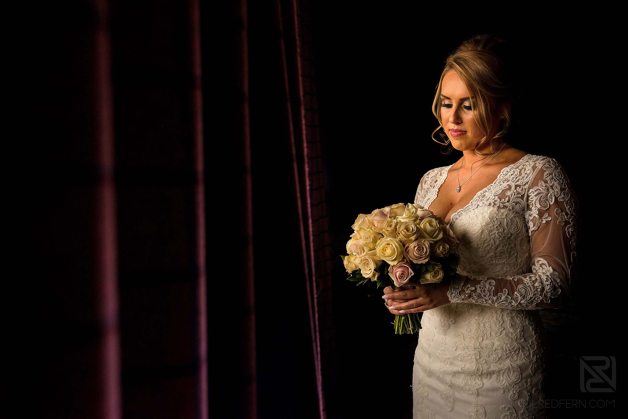 window light portrait of bride in honeymoon suite