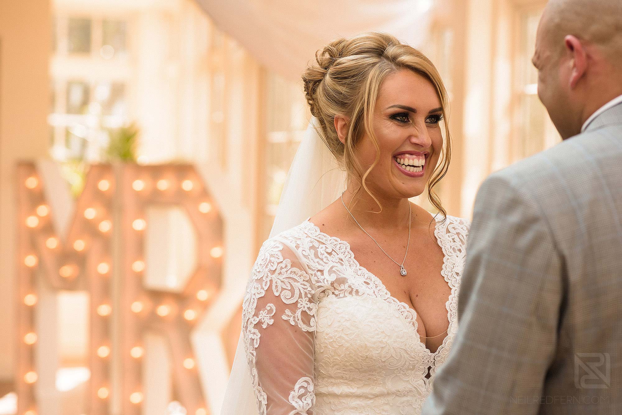 bride smiling during ceremony at Spring wedding at Mitton Hall