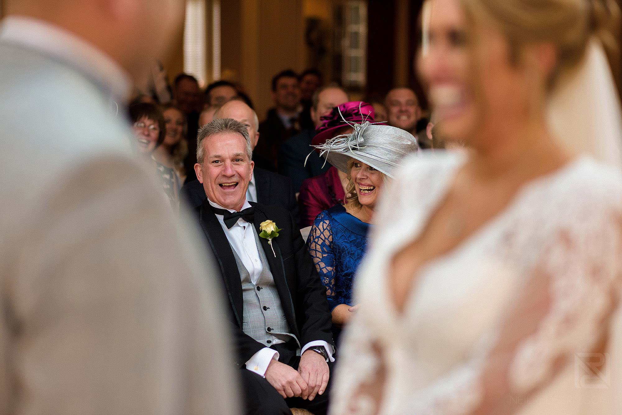parents laughing together during ceremony during Spring wedding at Mitton Hall