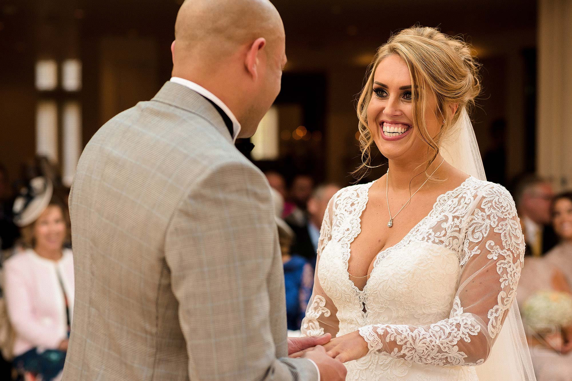 groom putting wedding ring on bride's finger