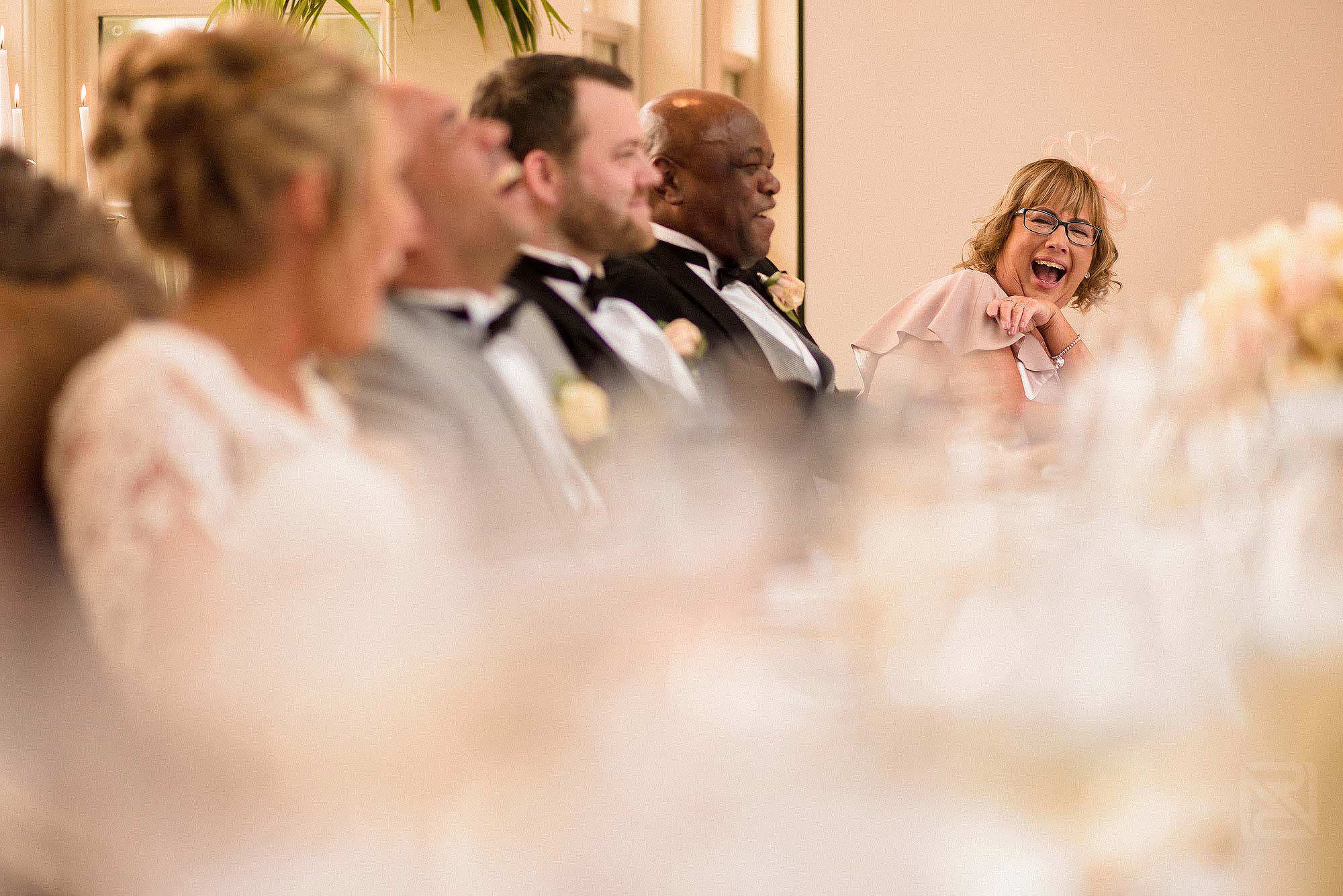 groom's mother laughing during speeches