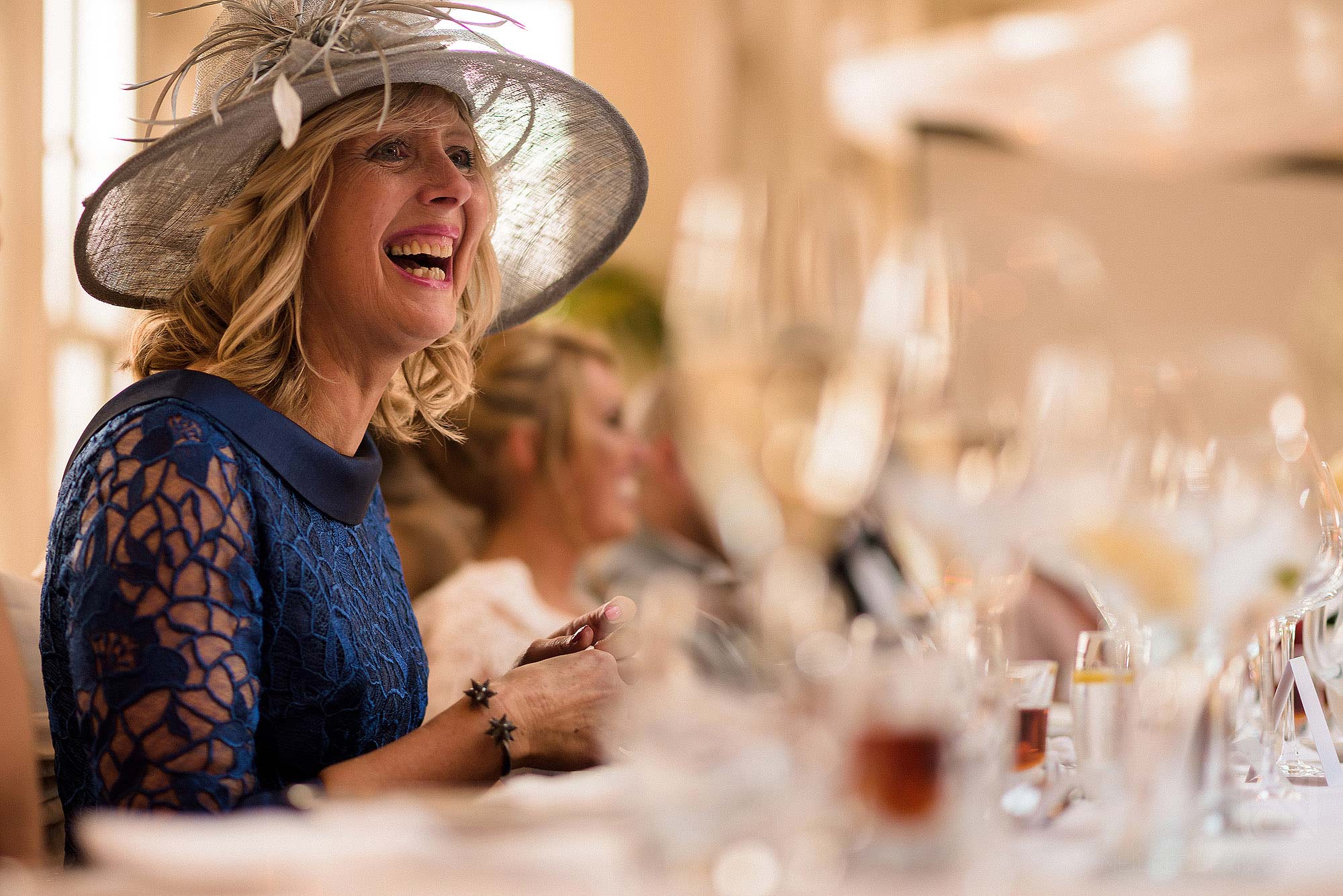 mother of bride laughing during wedding speeches
