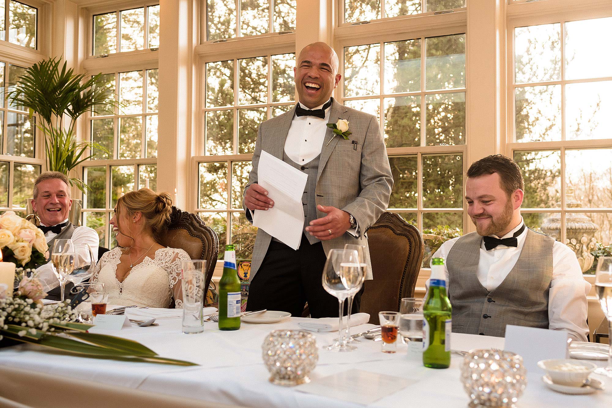 groom laughing during wedding speech