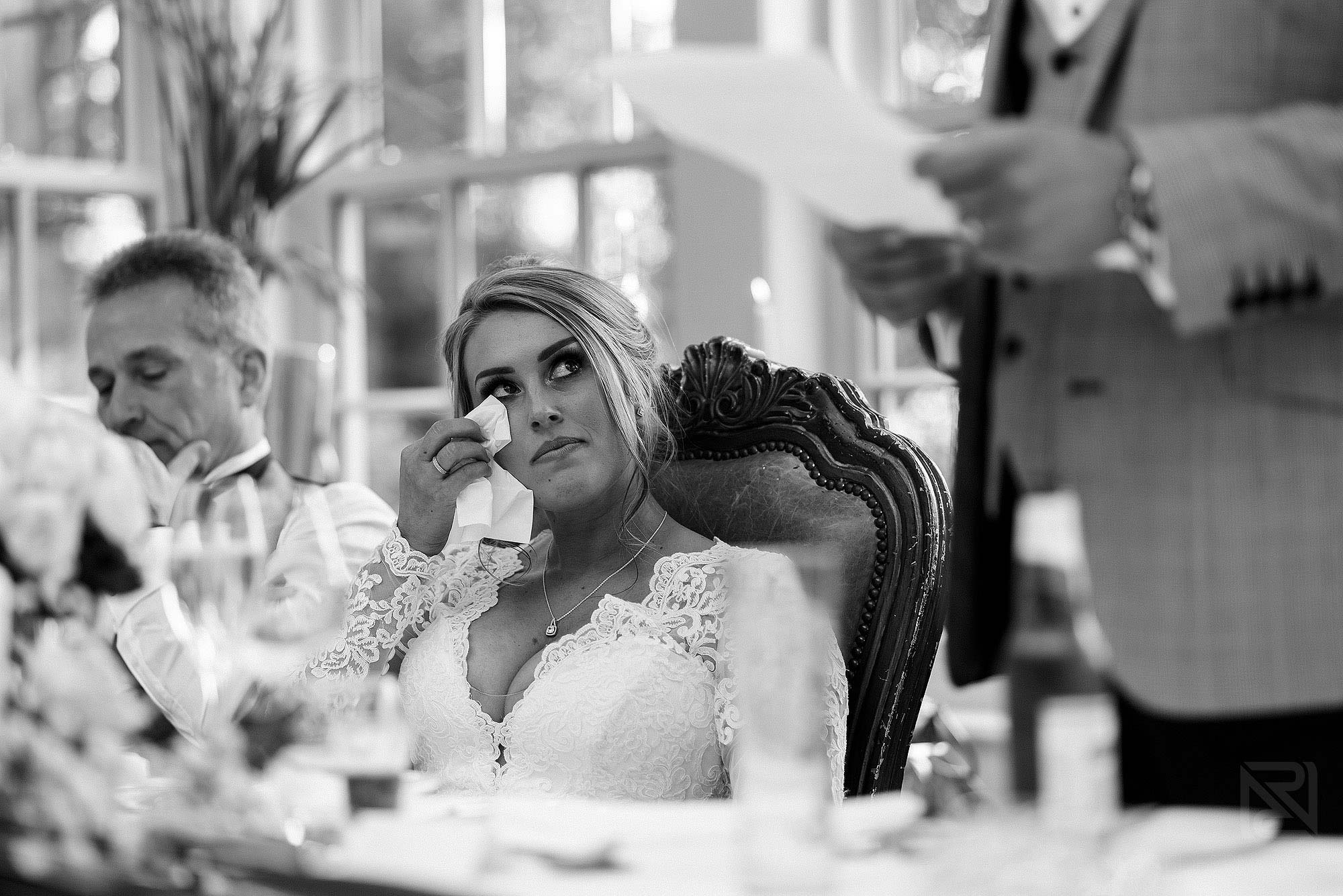 emotional moment of bride crying during groom's wedding speech