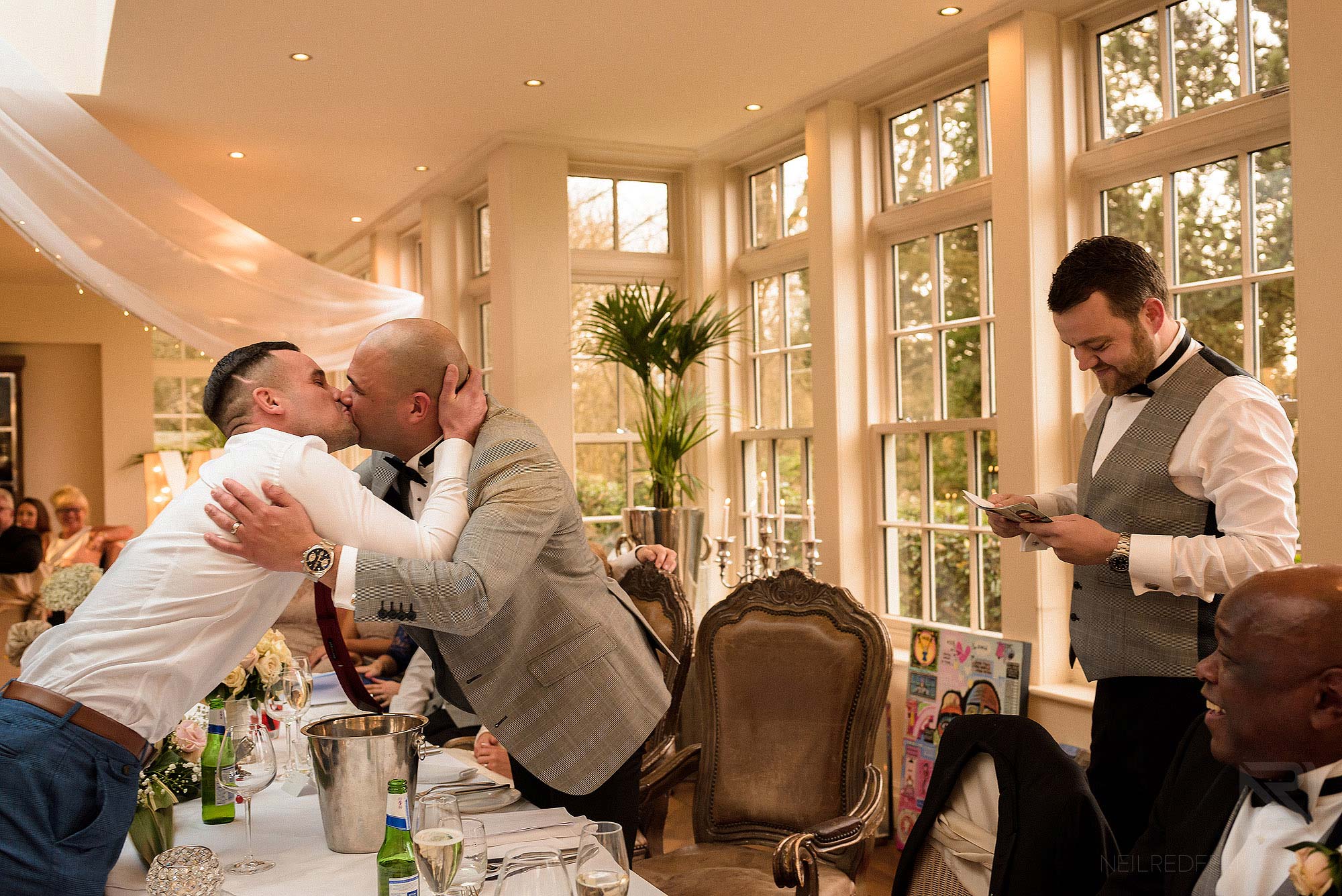 groom kissing wedding guest