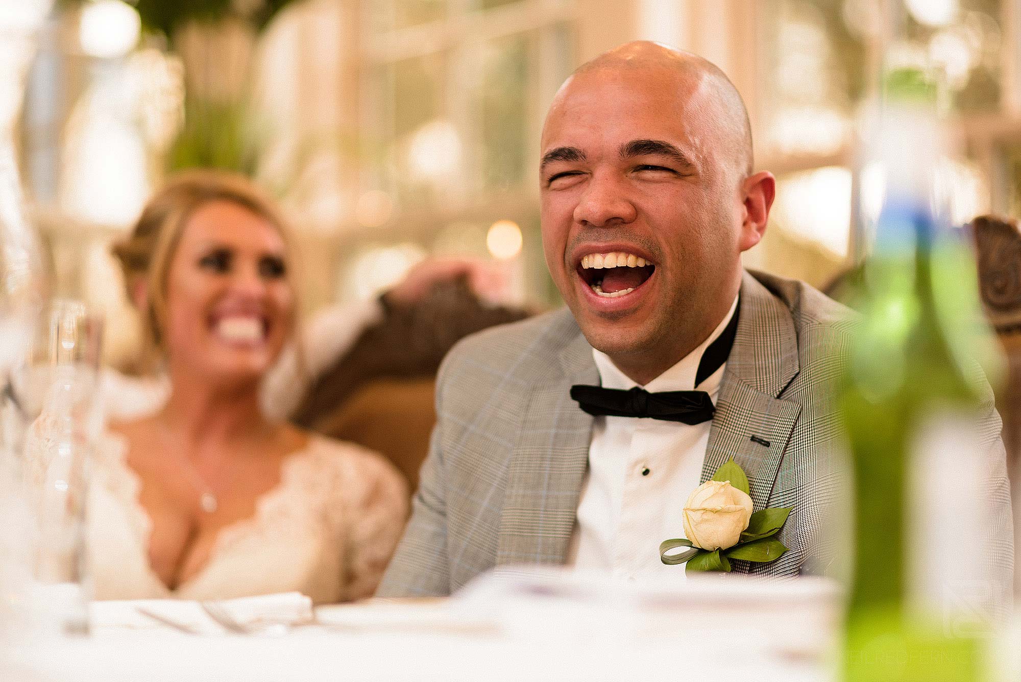groom laughing during Best Man's wedding speech