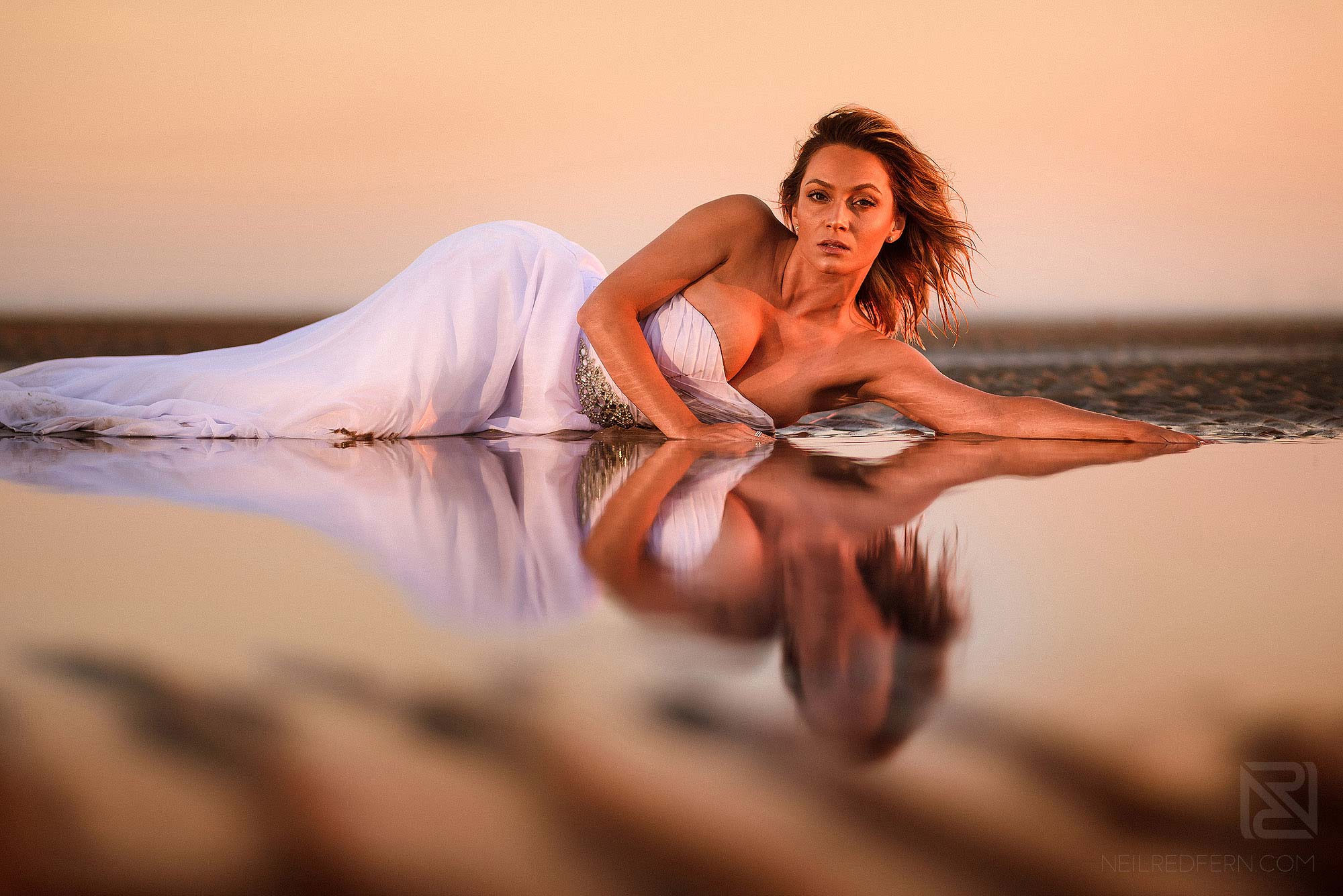 Trash the dress shoot on the beach 2 bride lay on sand on beach