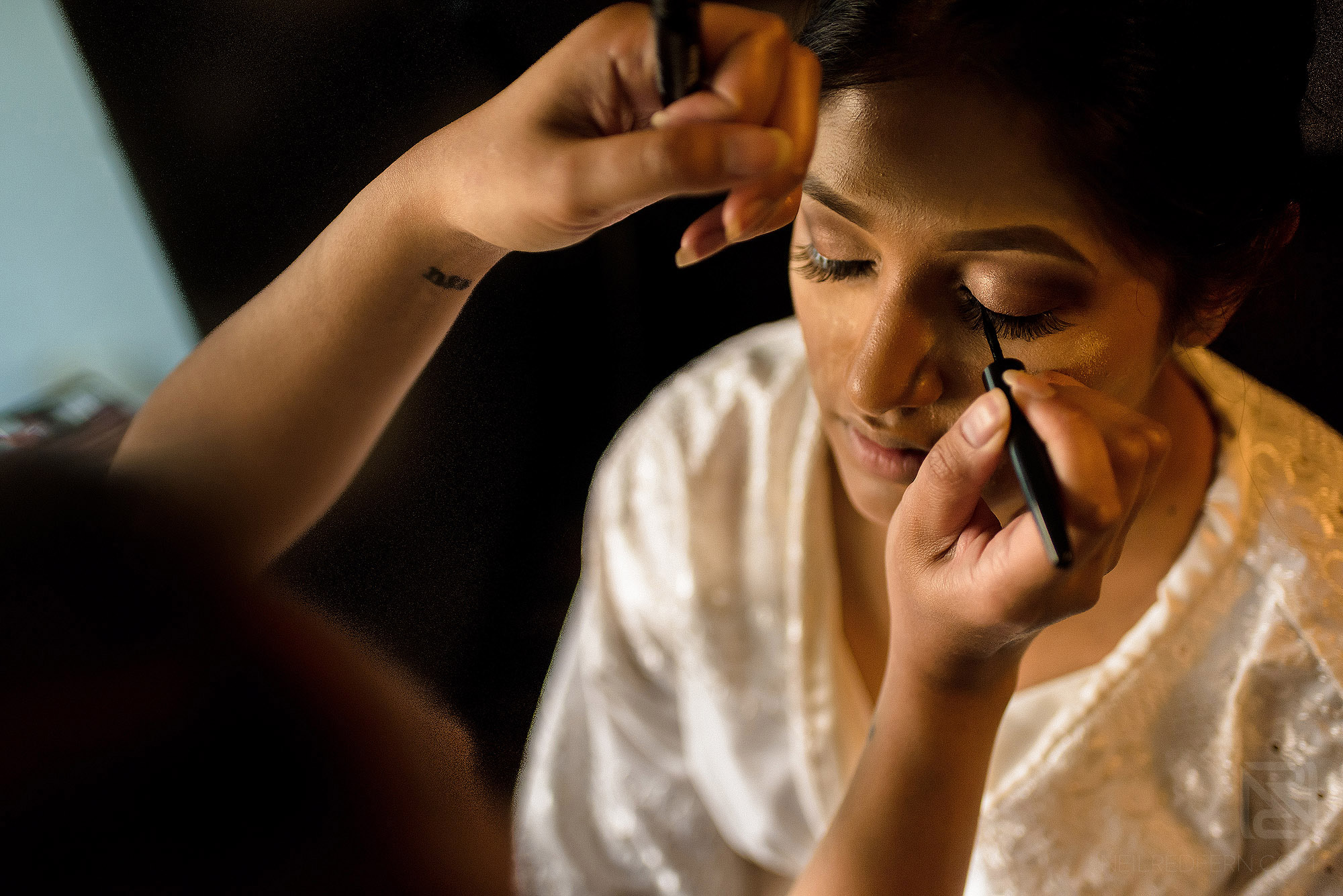 bride having make-up put on