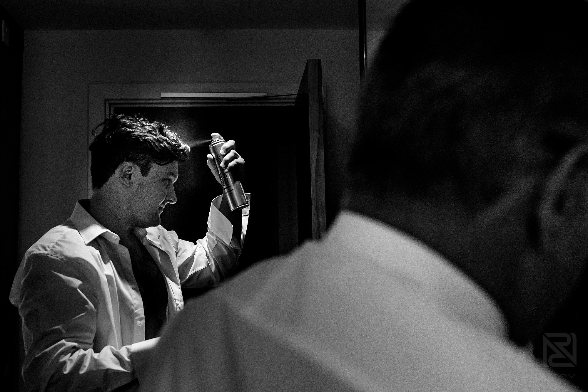 groom drying hair on morning of wedding
