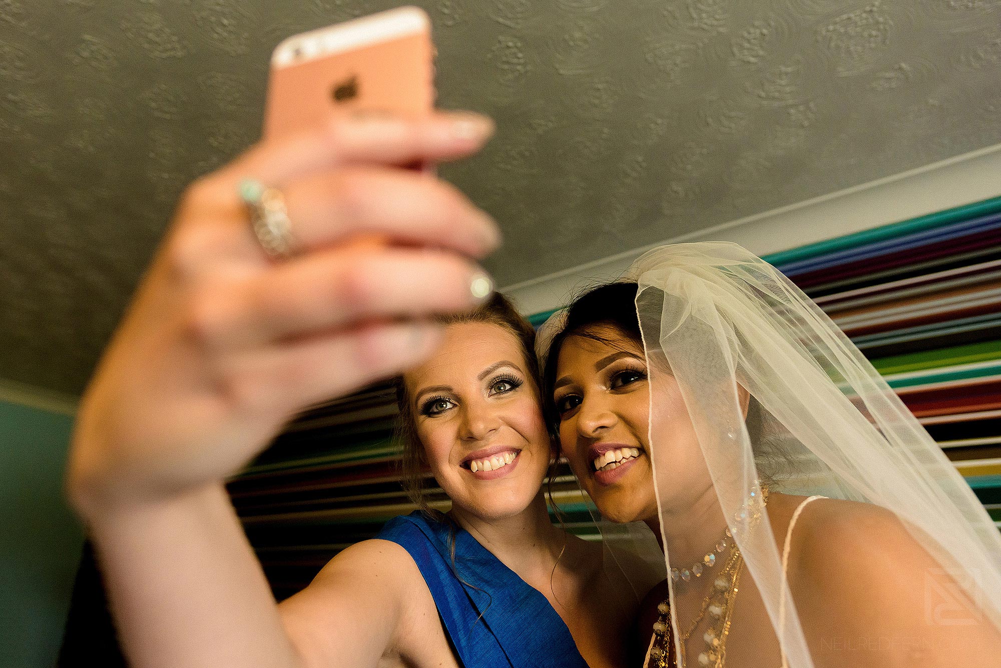 bride and bridesmaid having a fun selfie