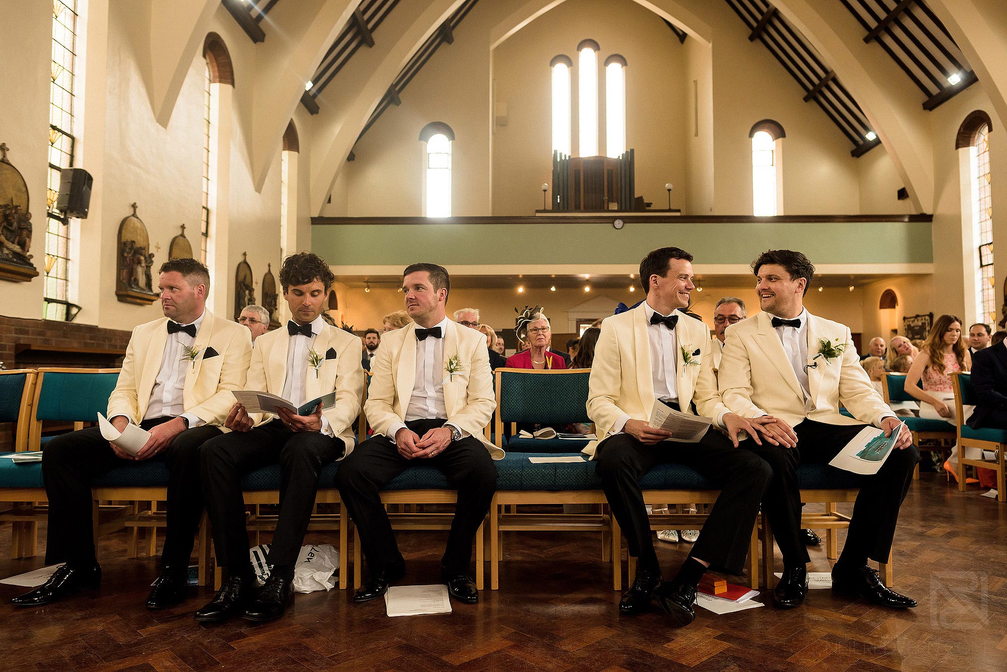 groomsmen sat together in church