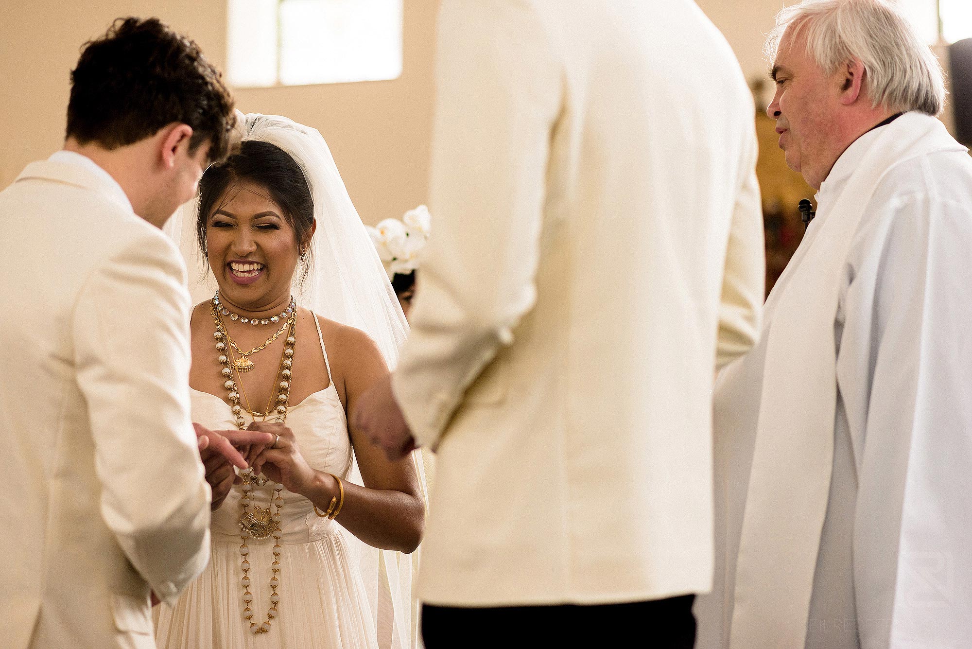 bride and groom exchanging wedding rings in church wedding ceremony