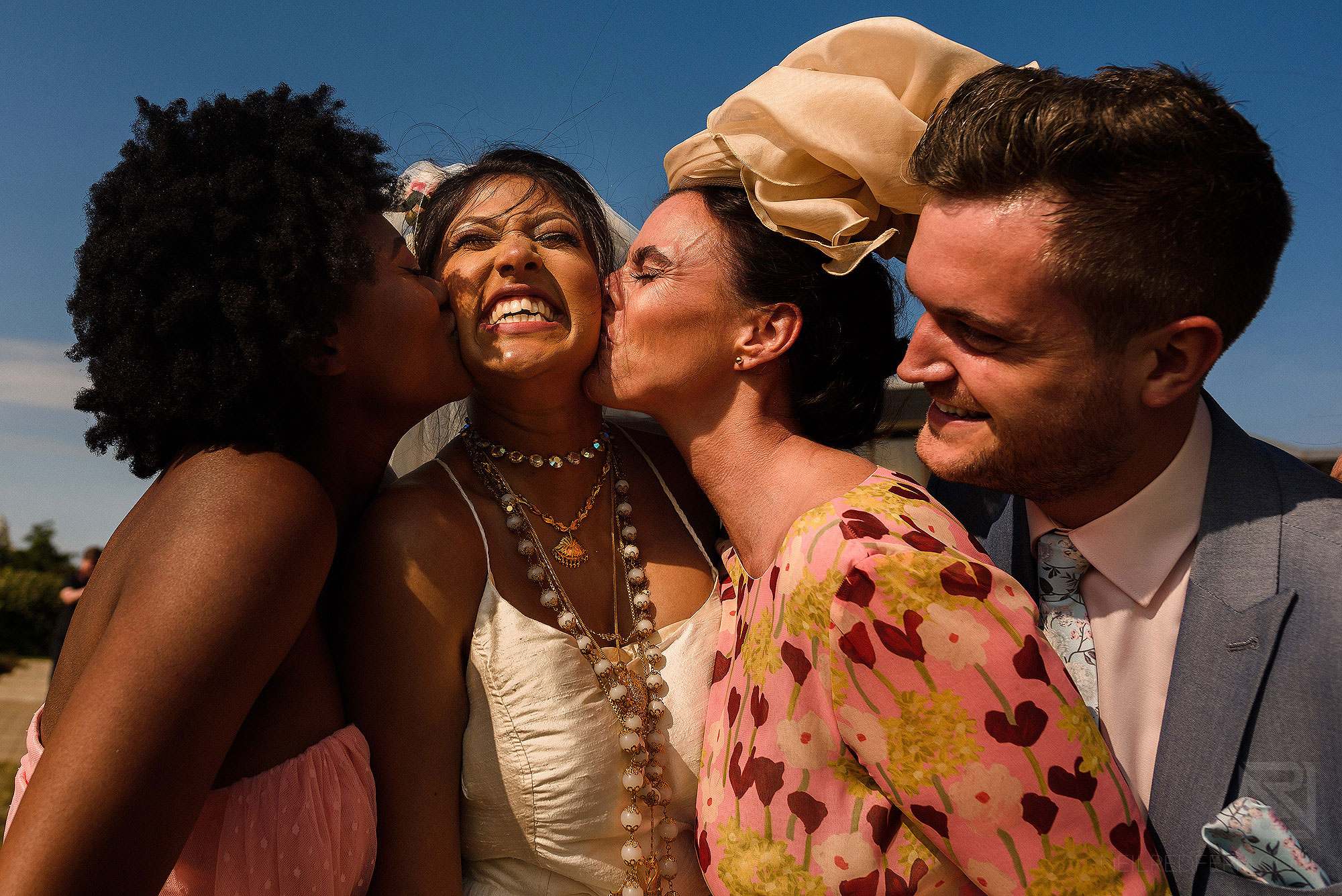 wedding guests kissing bride