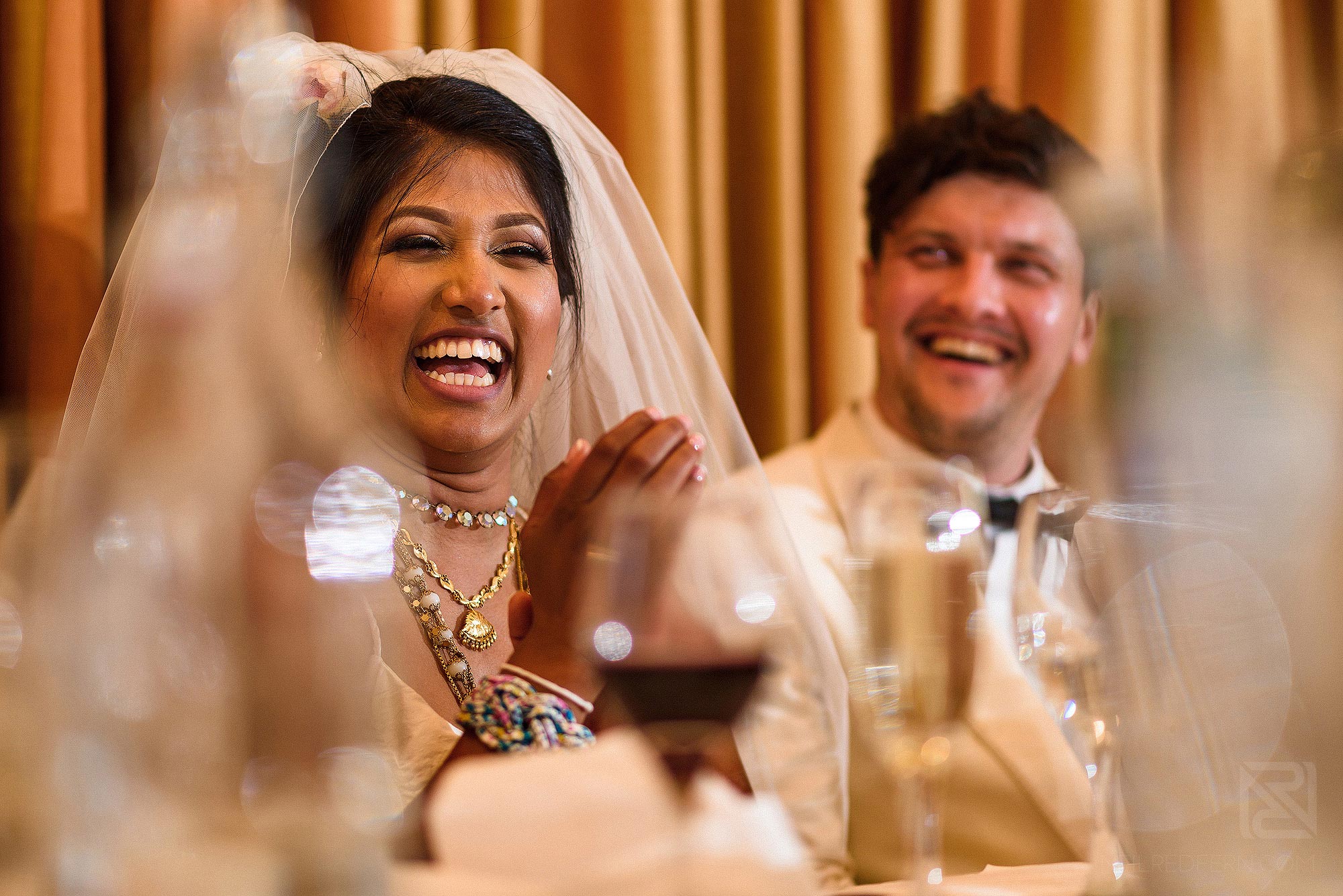 bride and groom laughing during Best Man's wedding speech