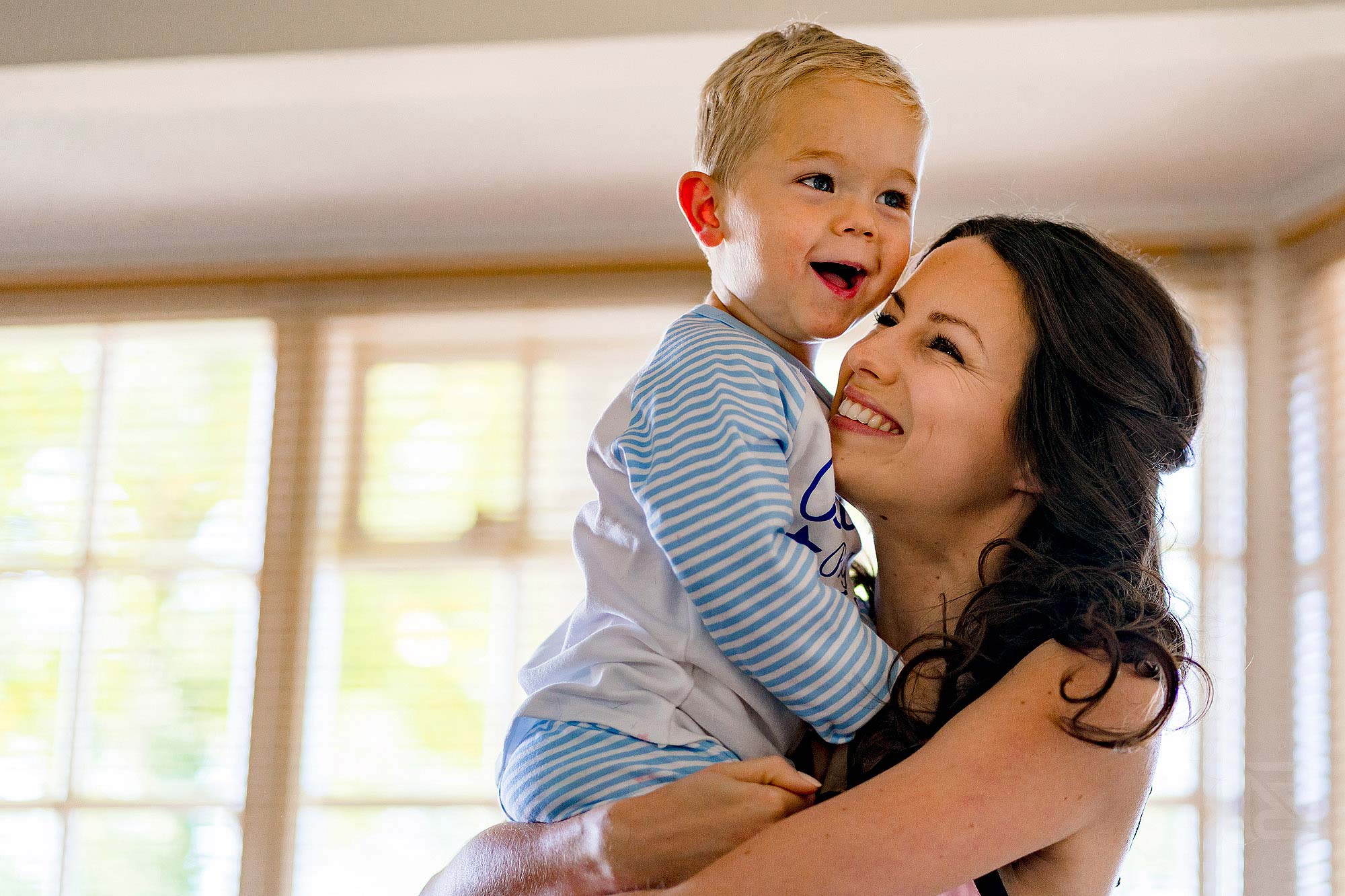 smiling bride with page boy during wedding preparations