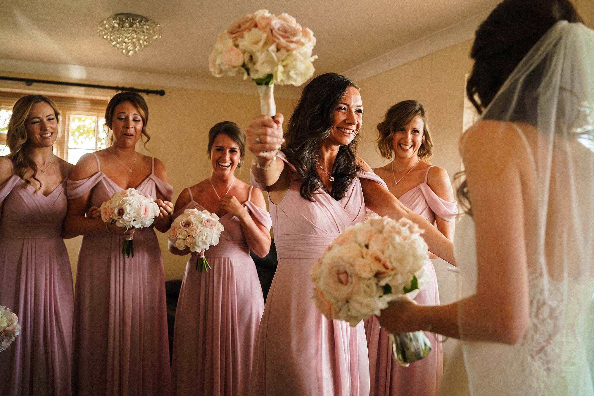 emotional bridesmaid hugging bride