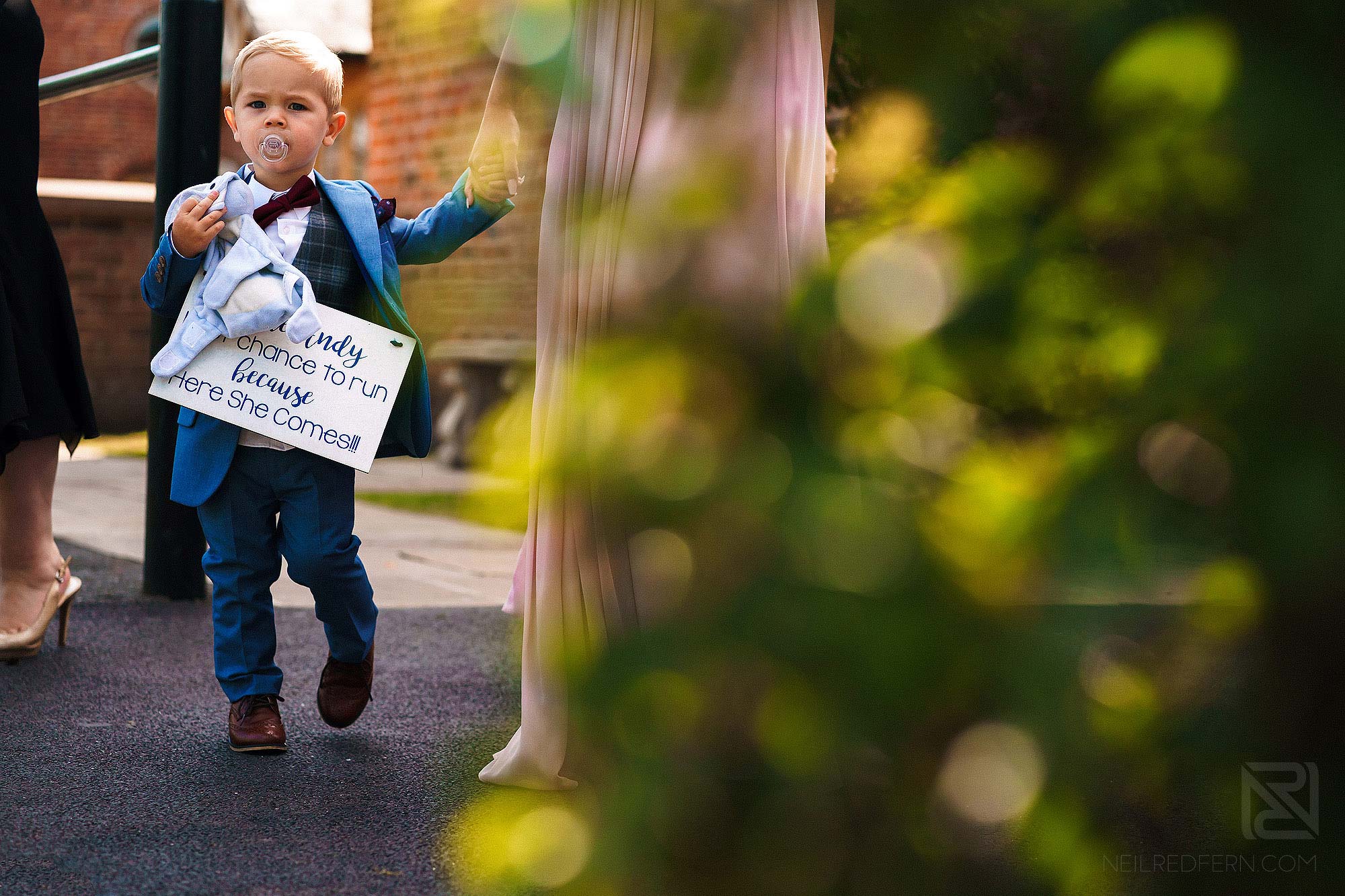 page boy carrying sign