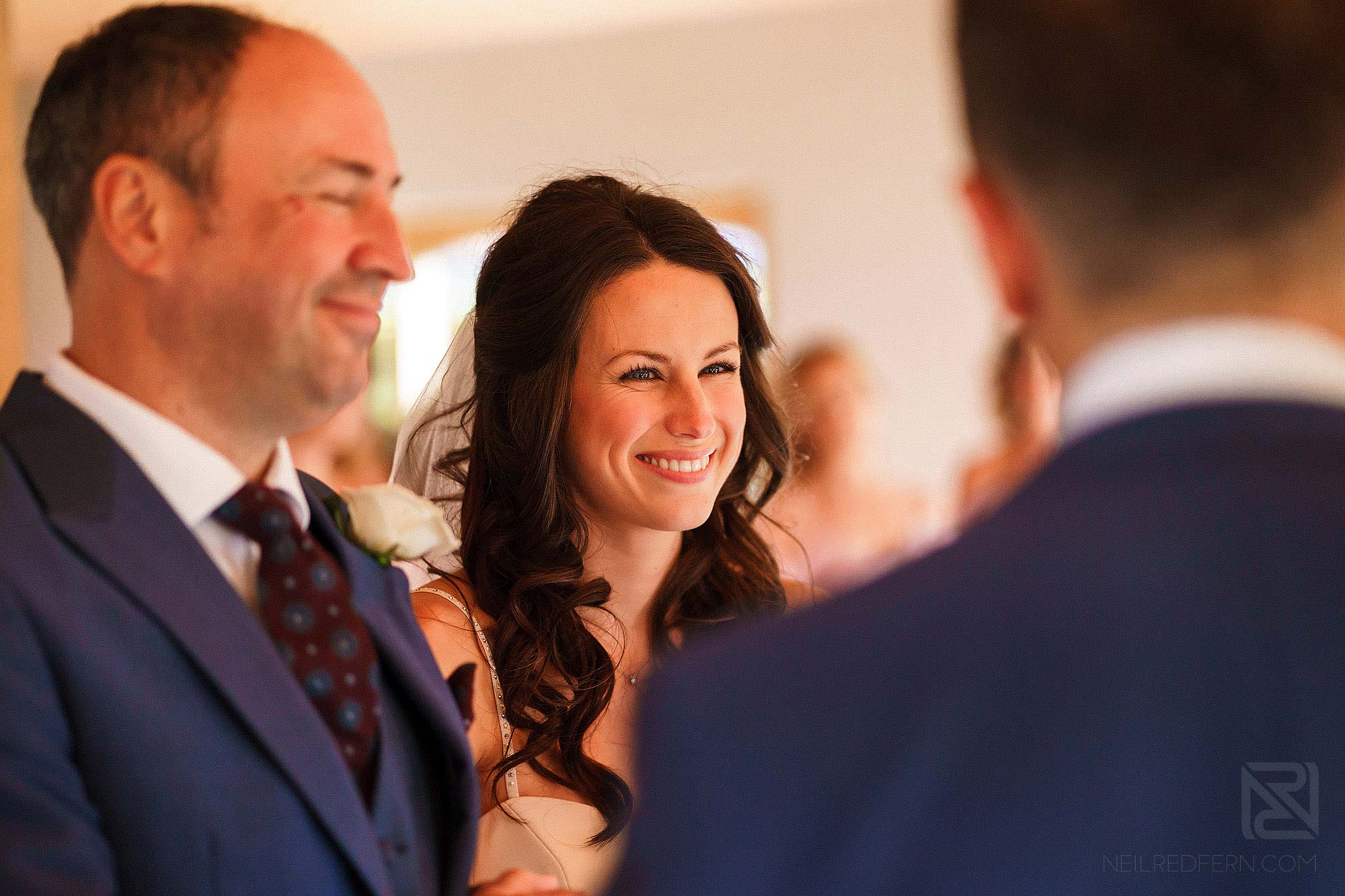 bride smiling at groom during wedding ceremony