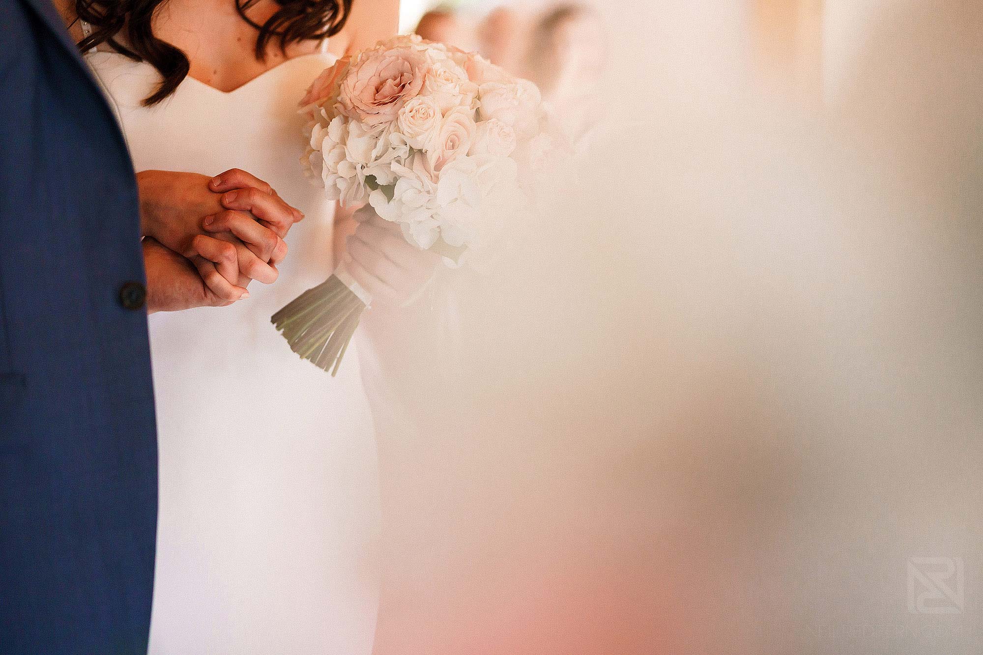 bride and groom holding hands during wedding ceremony