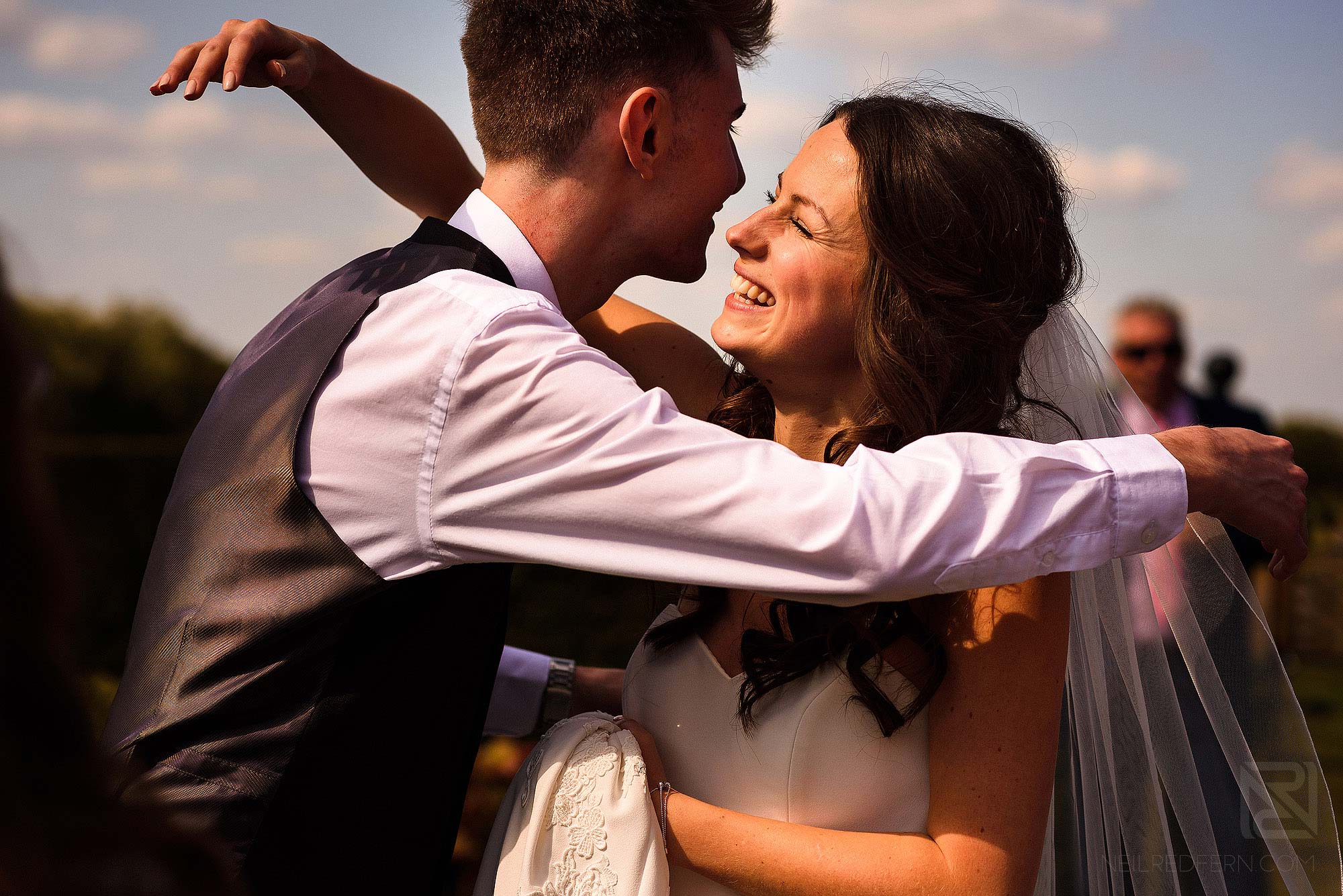 friend congratulating bride during drinks reception