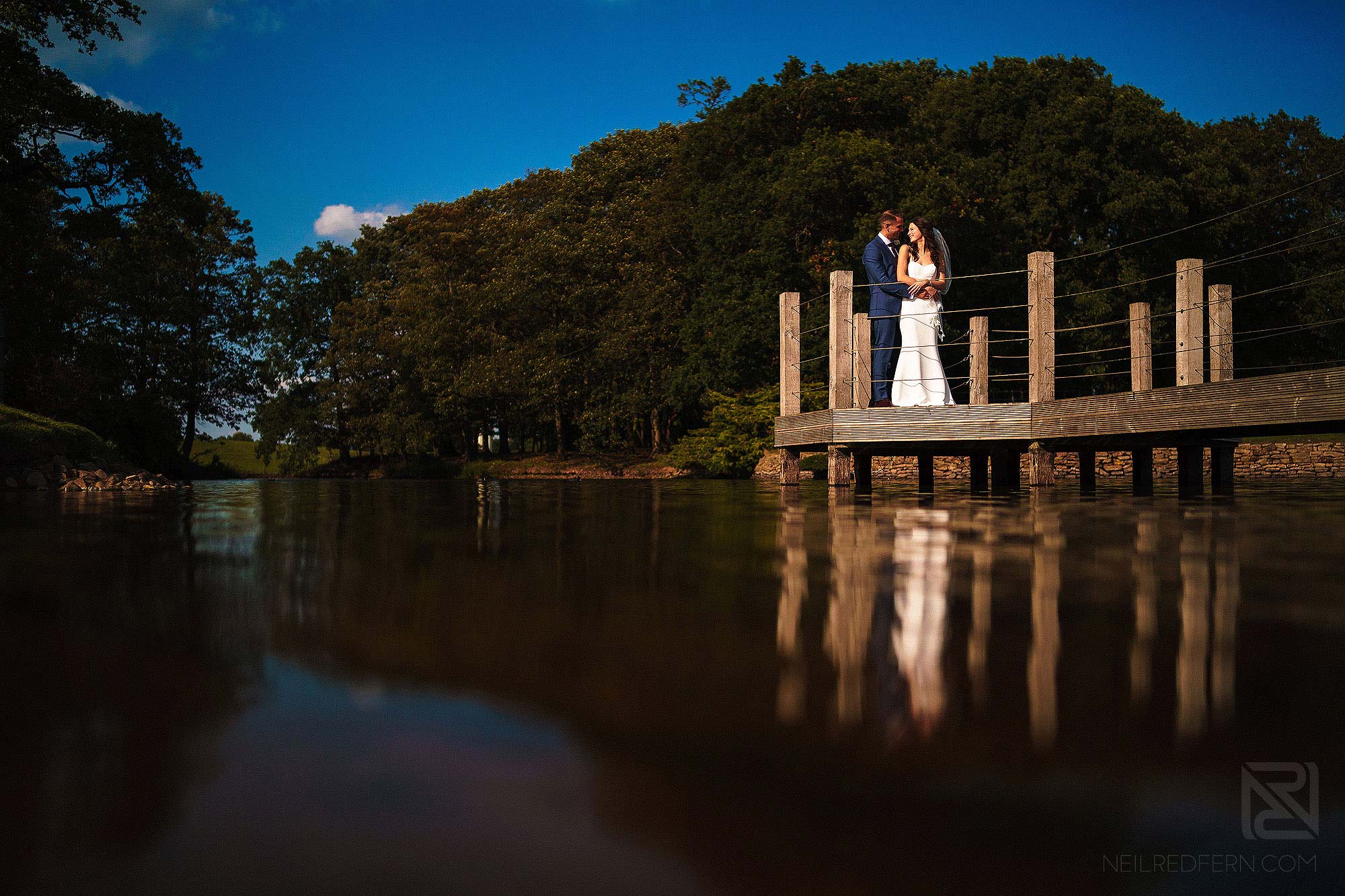 bride and groom on jetty at Merrydale Manor wedding