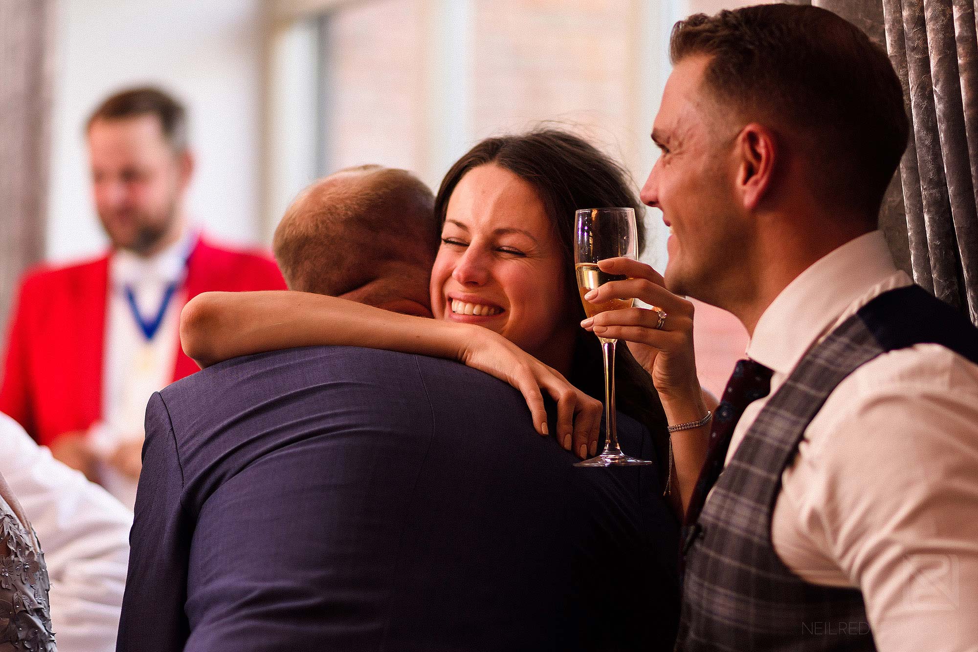 friend hugging happy bride