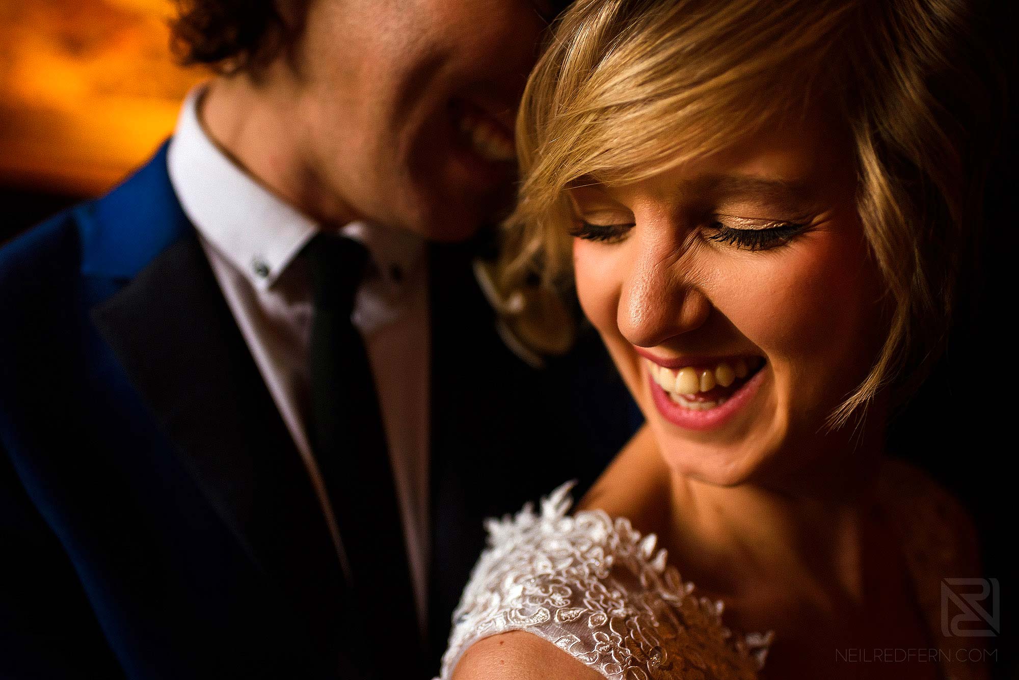 close up of bride and groom laughing