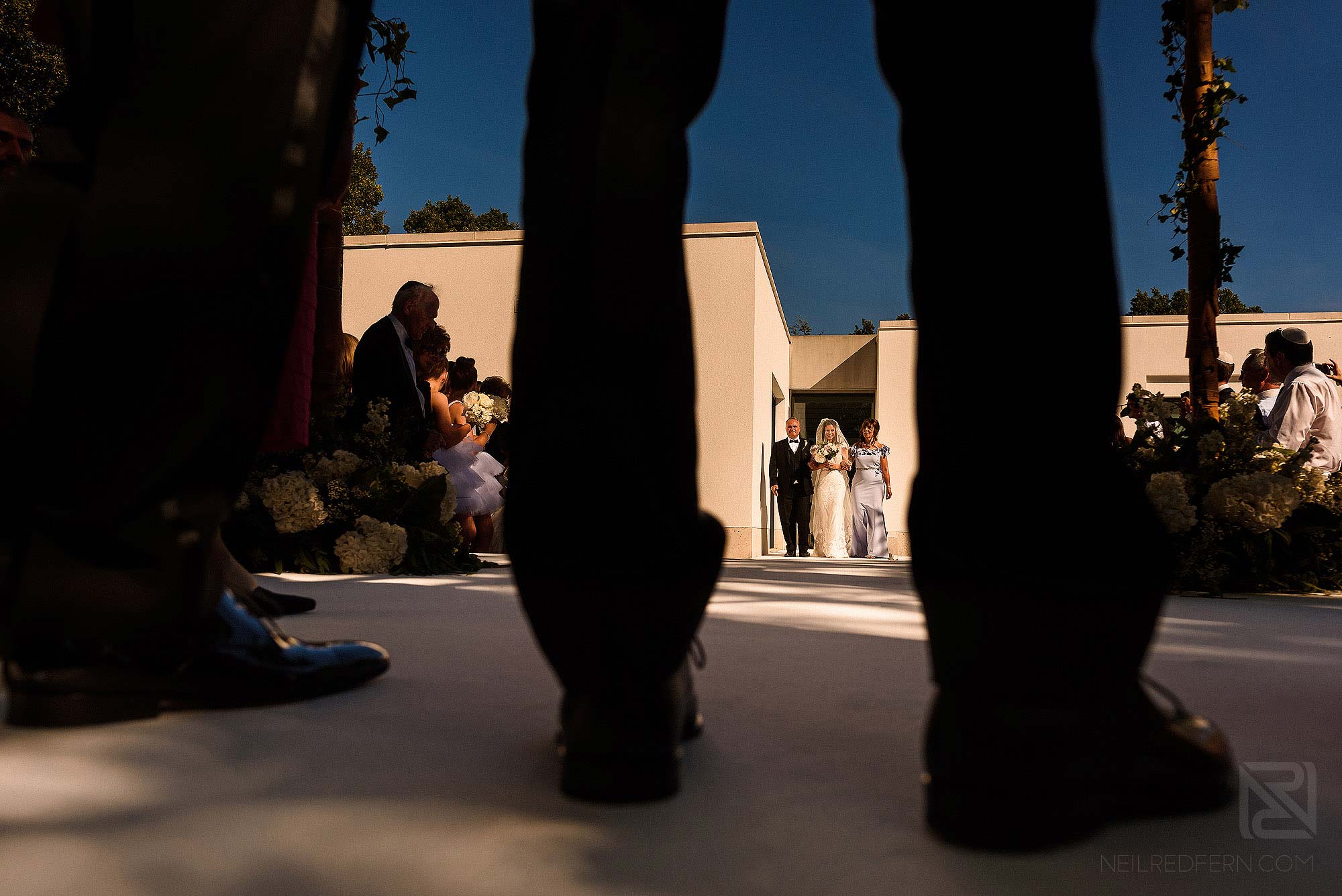bride and parents walking down the aisle