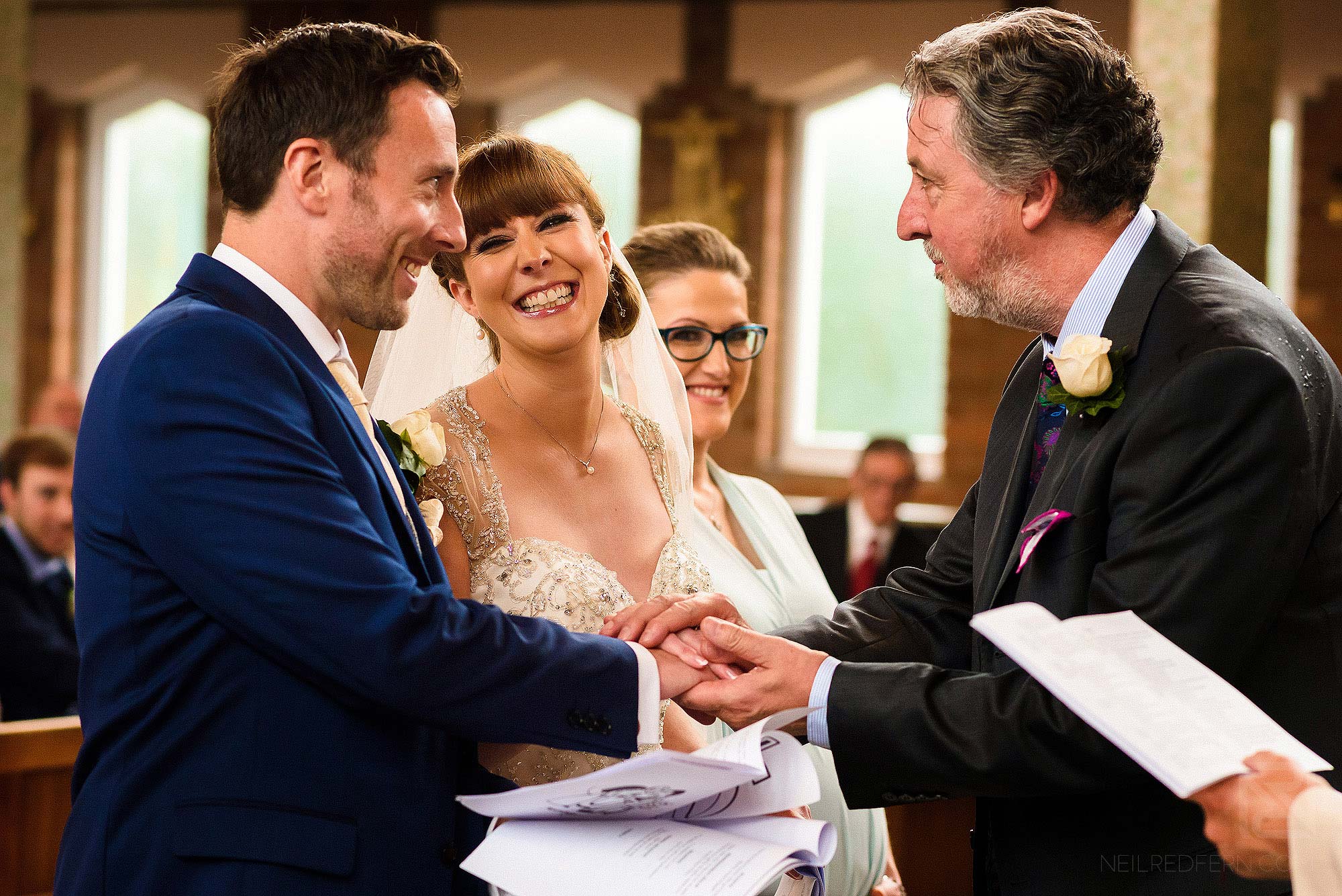 father of bride handing over daughter's hand to groom