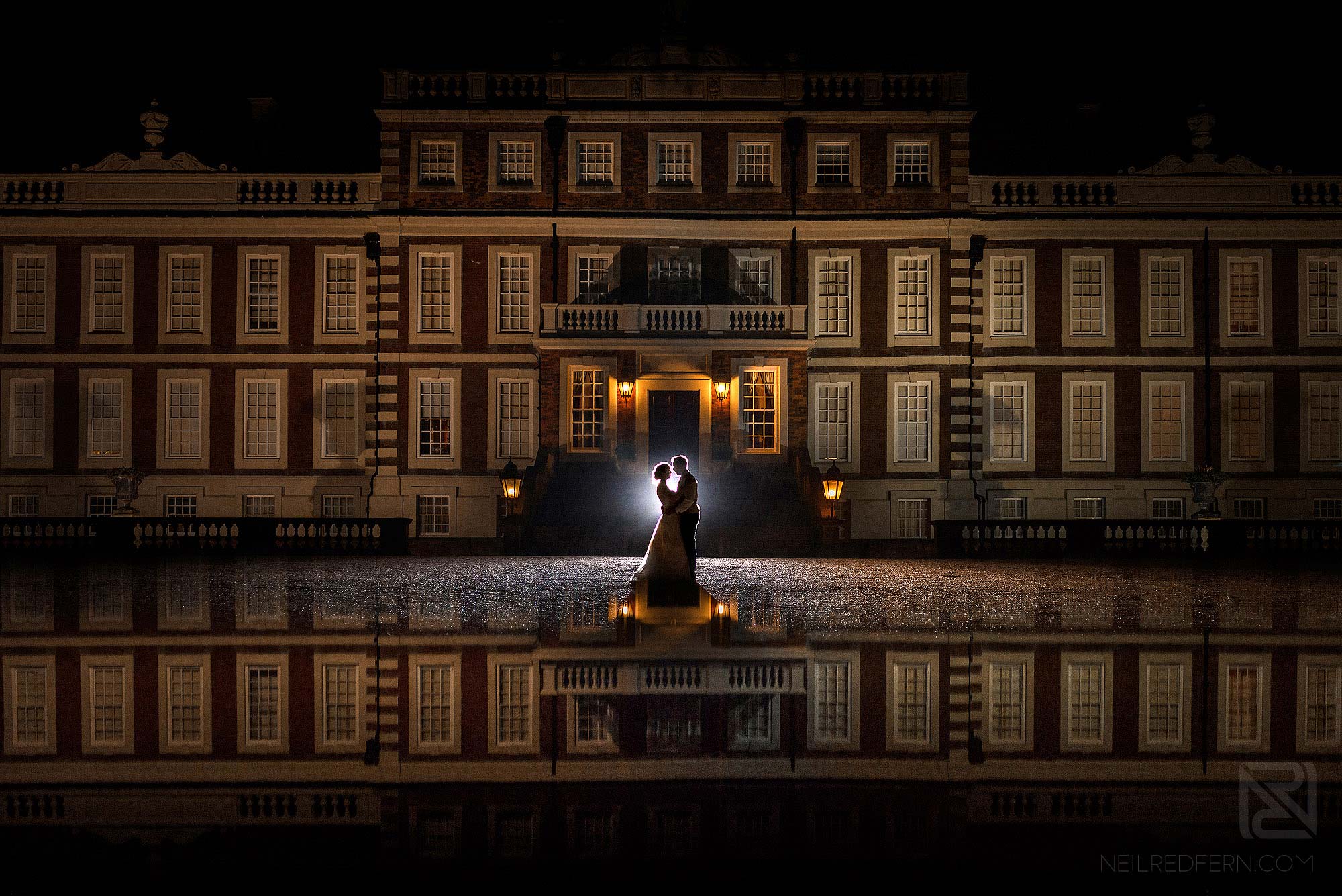 creative nighttime portrait of bride and groom at Knowsley Hall