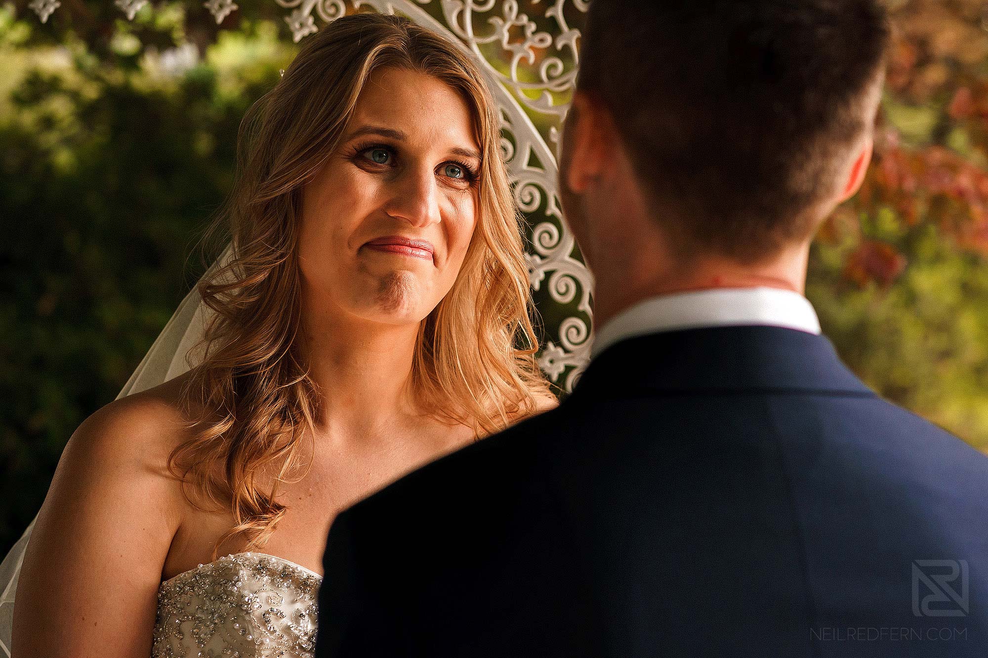 bride looking emotional during outside wedding ceremony in Lake District